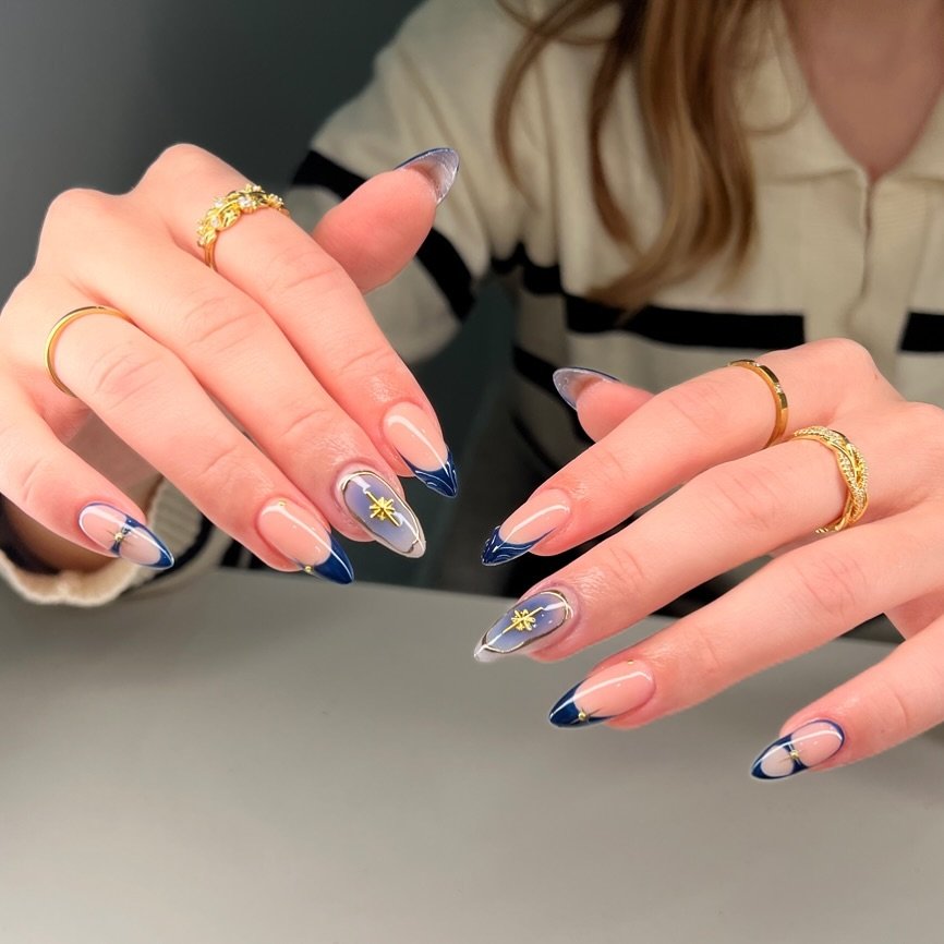 Blue Christmas nails idea 4: Navy and Nude Almond Nails with Patterned French Tips
