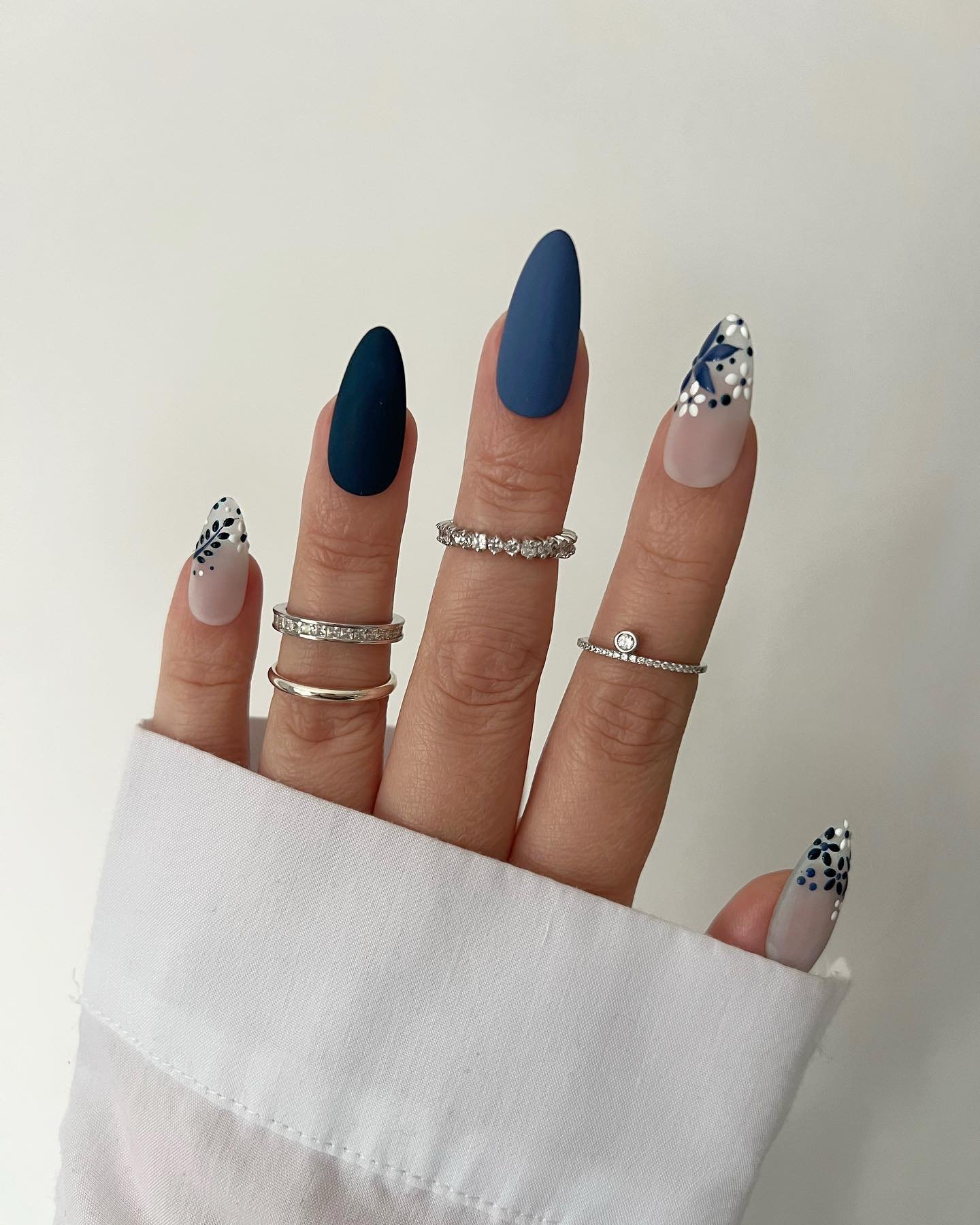 Blue Christmas nails idea 13: Navy and Nude Nails with Black-and-White Patterned Tips