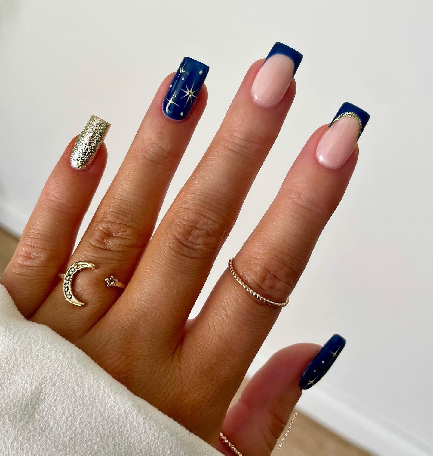 Blue Christmas nails idea 16: Nude Almond Nails with Navy Tips and a Gold Glitter Accent