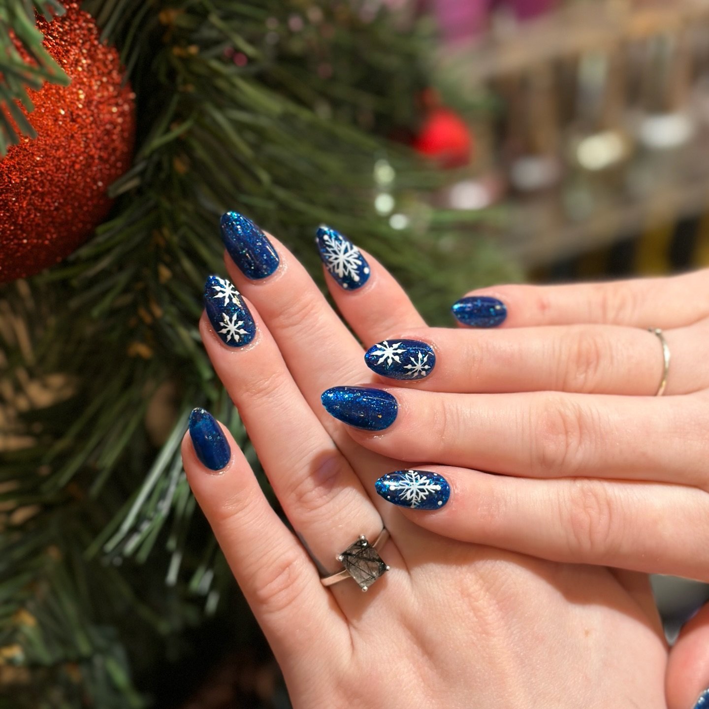 Blue Christmas nails idea 17: Navy Blue Christmas Nails with White Snowflakes