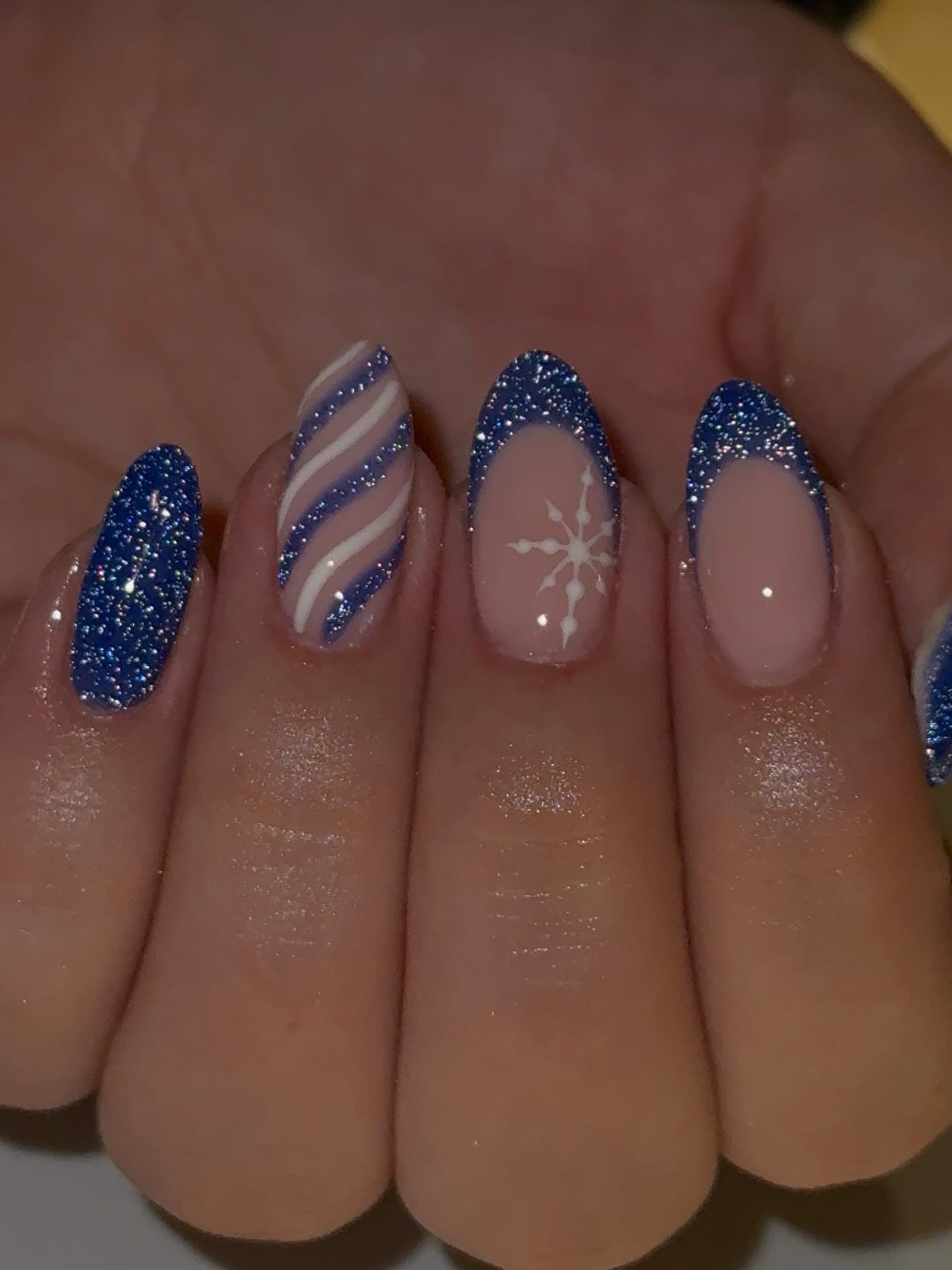 Blue Christmas nails idea 19: Glitter Blue French Tips with Sheer Pink Winter Accents