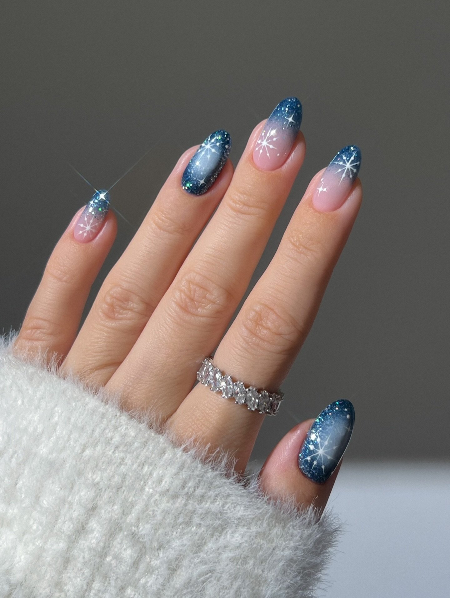Blue Christmas nails idea 22: Pink and Blue Glitter Almond Nails with Snowflake Details