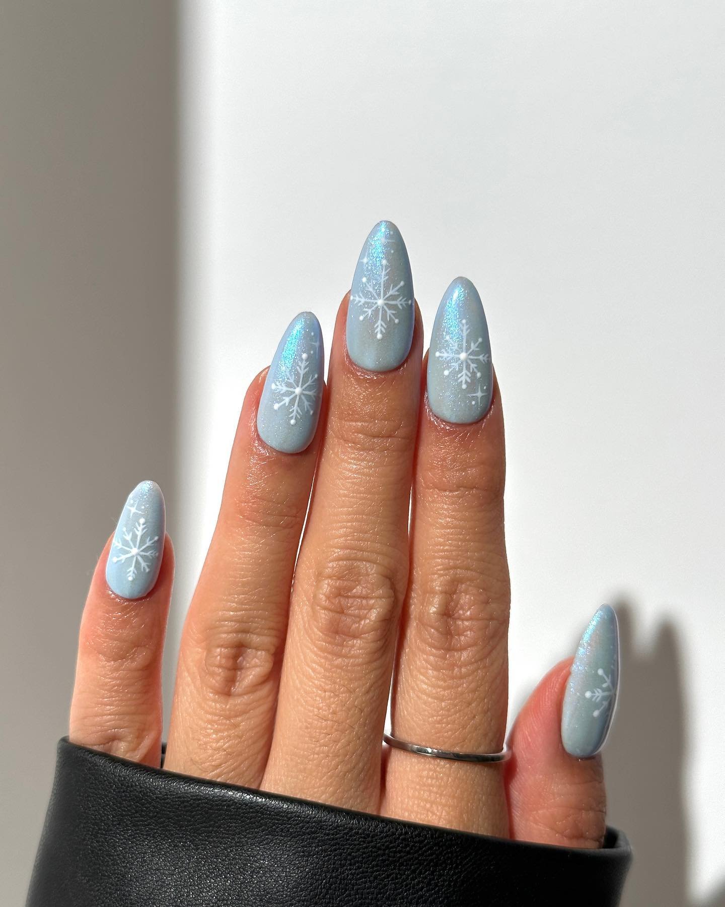 Blue Christmas nails idea 24: Pale Blue and Silver Almond Nails with Snowflake Details