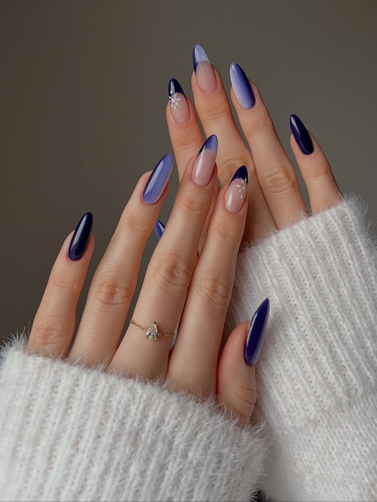 Blue Christmas nails idea 25: Navy, Silver, and Nude Almond Nails with Winter Accents