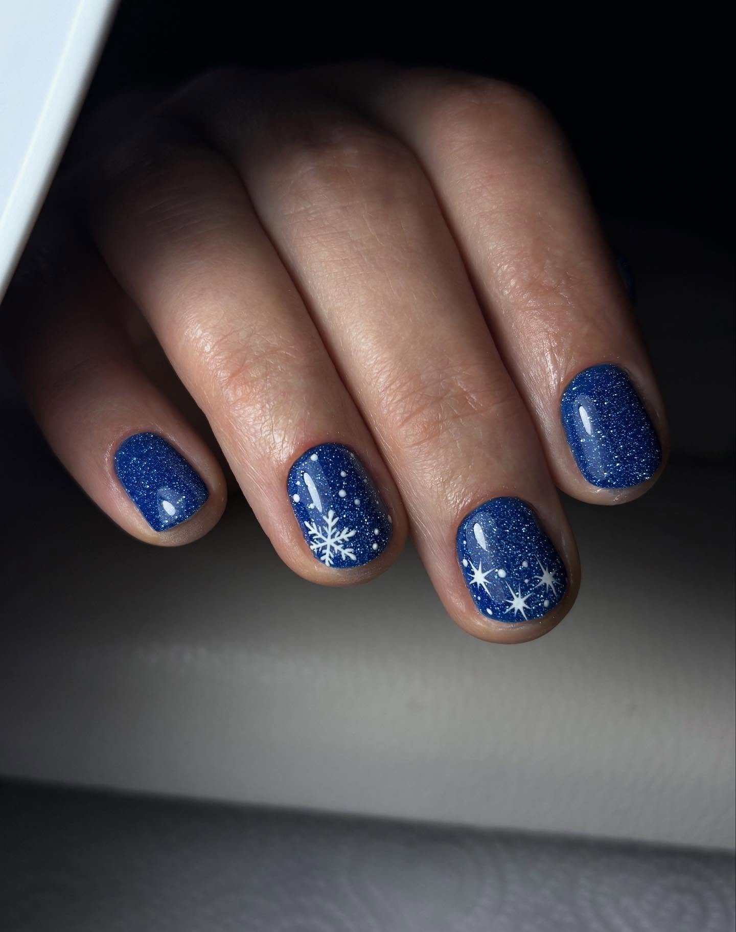 Blue Christmas nails idea 27: Short Navy Blue Nails with White Snowflakes and Dots