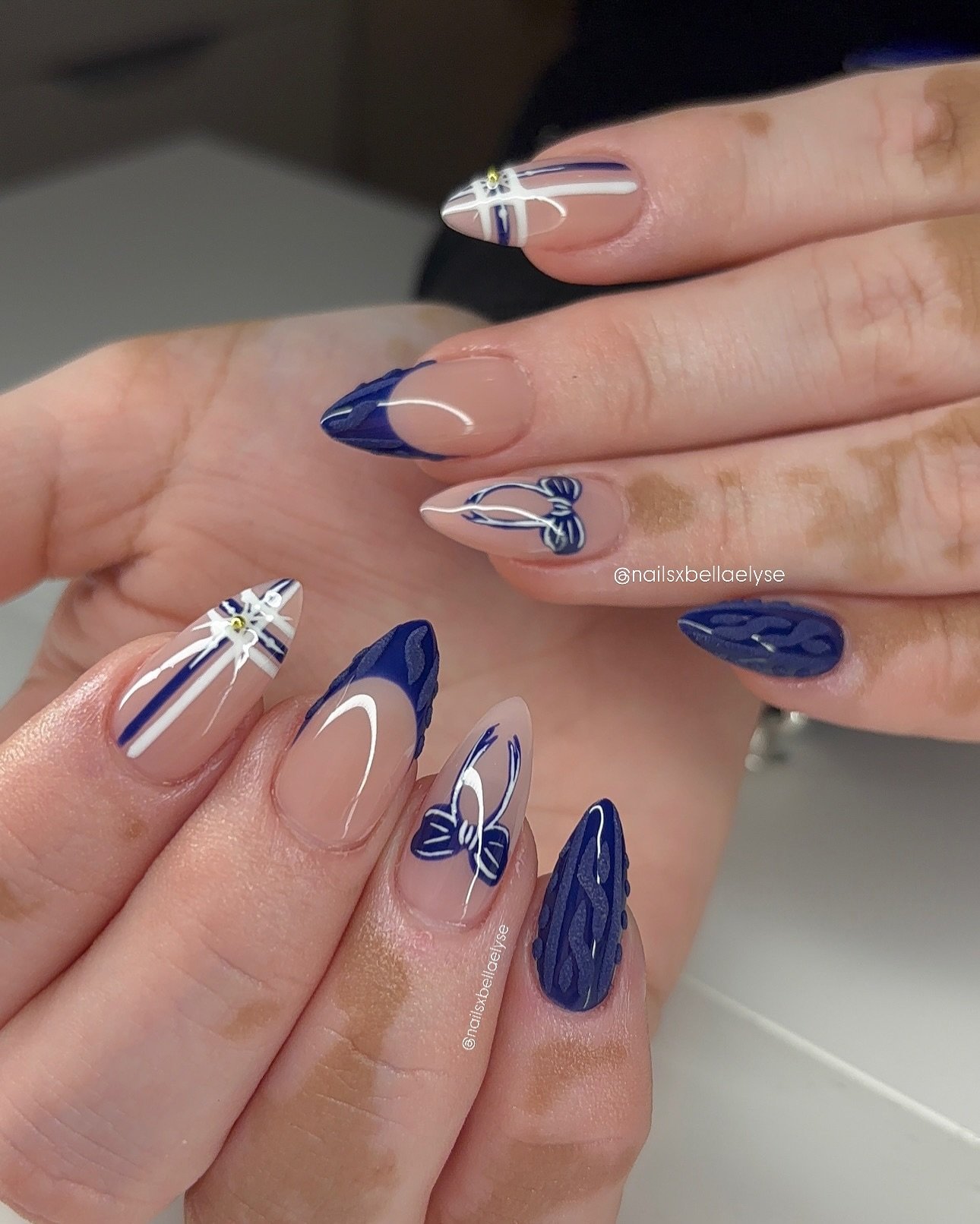 Blue Christmas nails idea 28: Sheer Pink and Navy Almond Nails with Blue Line Art