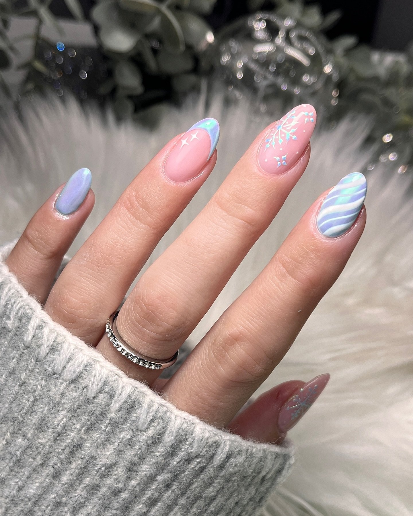 Blue Christmas nails idea 30: Soft Pink and Blue Almond Nails with Snowflakes and Waves