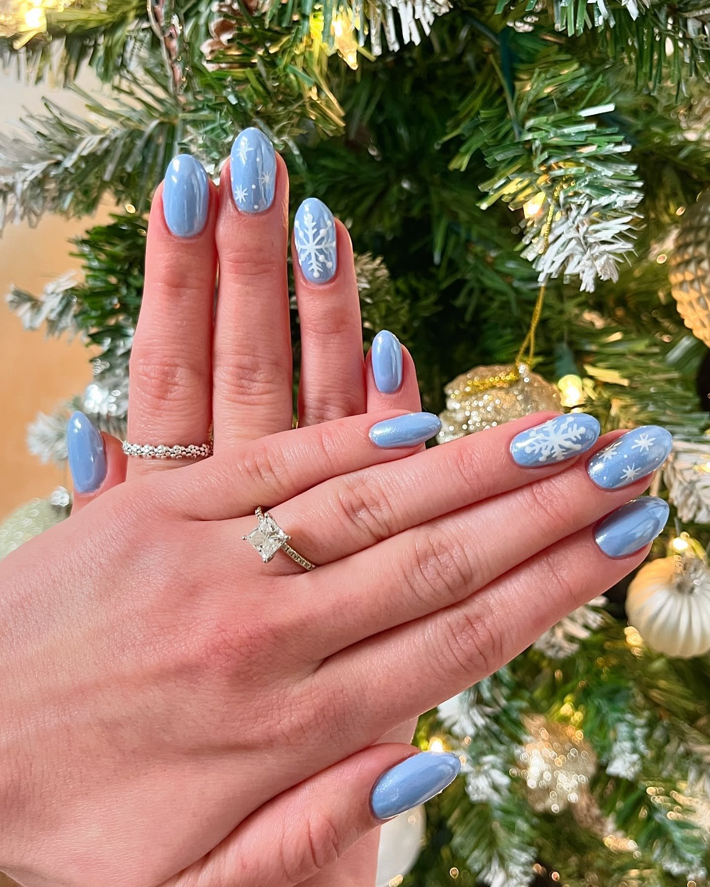 Blue Christmas nails idea 31: Blue and Icy Winter Almond Nails with Snowflakes and Glitter