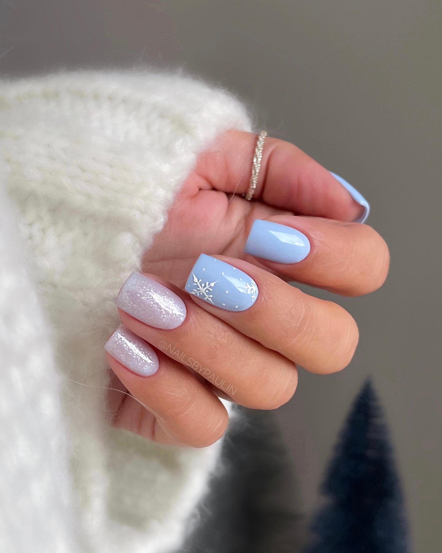 Blue Christmas nails idea 36: Soft Pink and Pale Blue Nails with Frosted Winter Accents