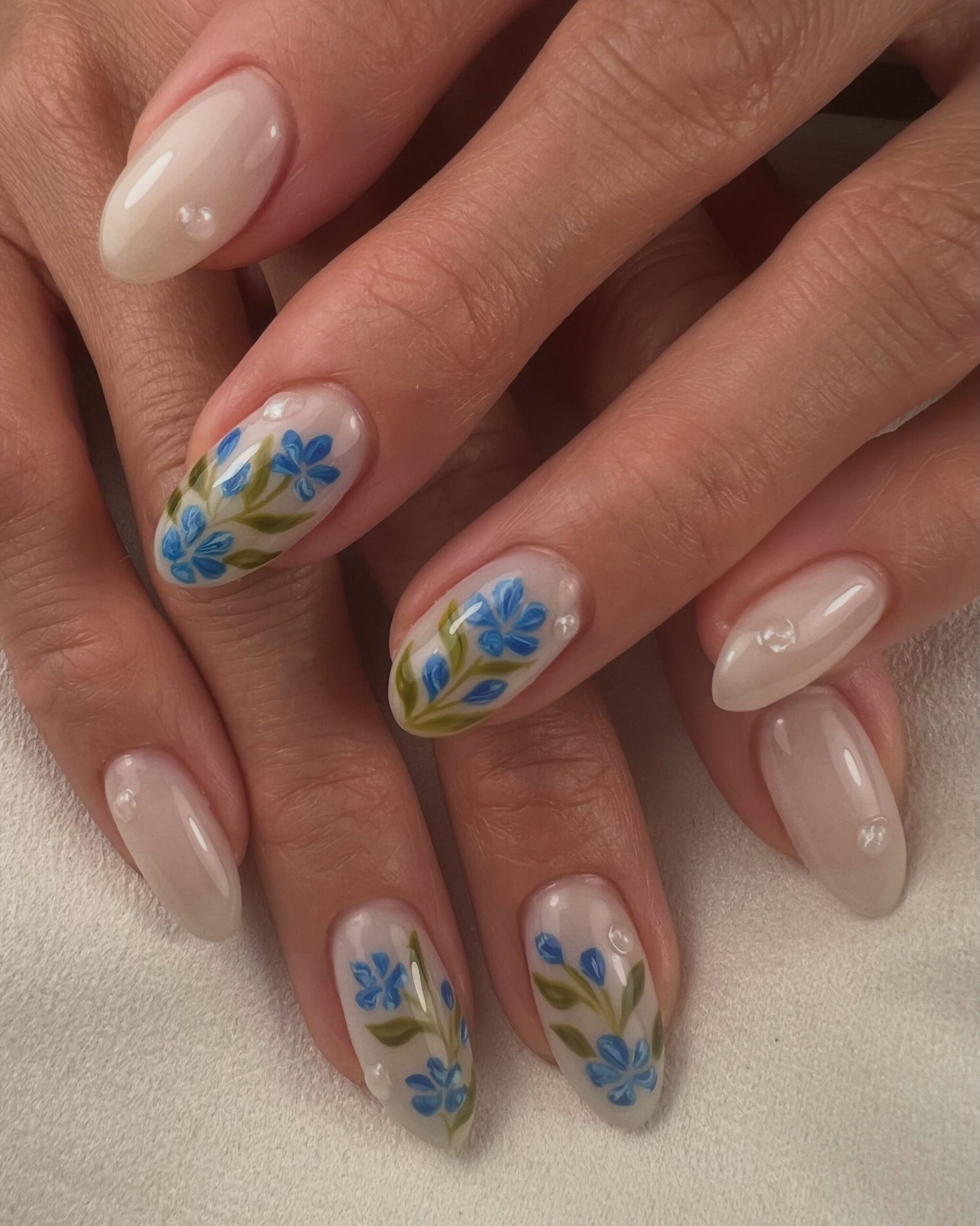 Sheer Nude Almond Nails with Blue and Yellow Floral Art