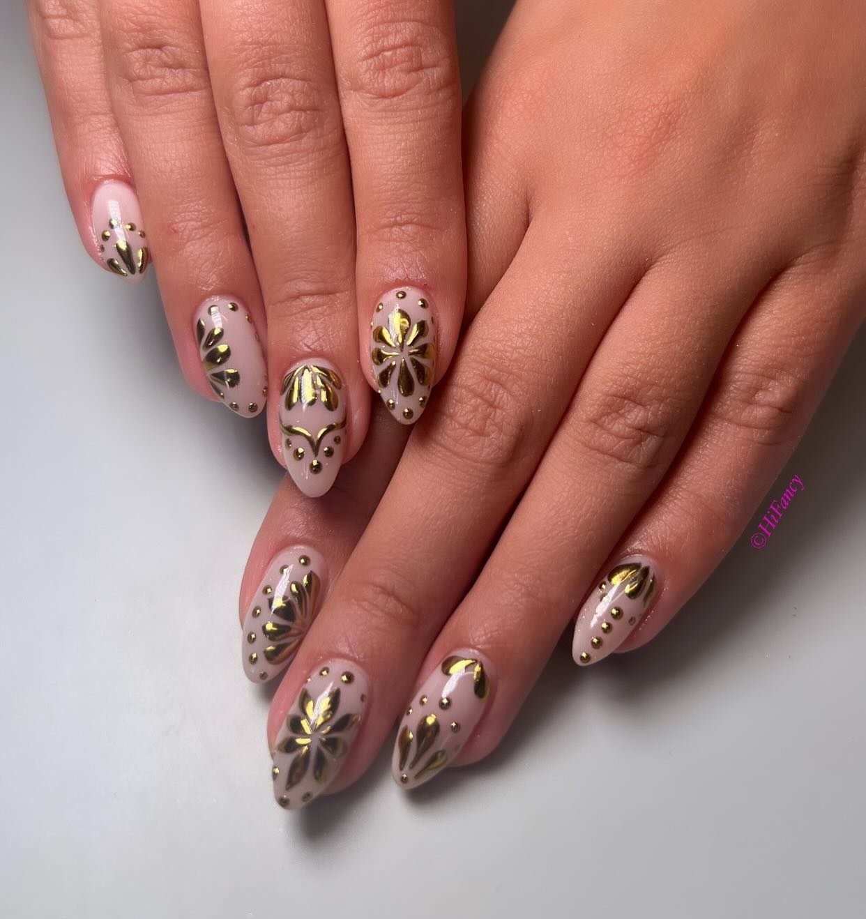 Nude Almond Nails with Black and Gold Botanical Details