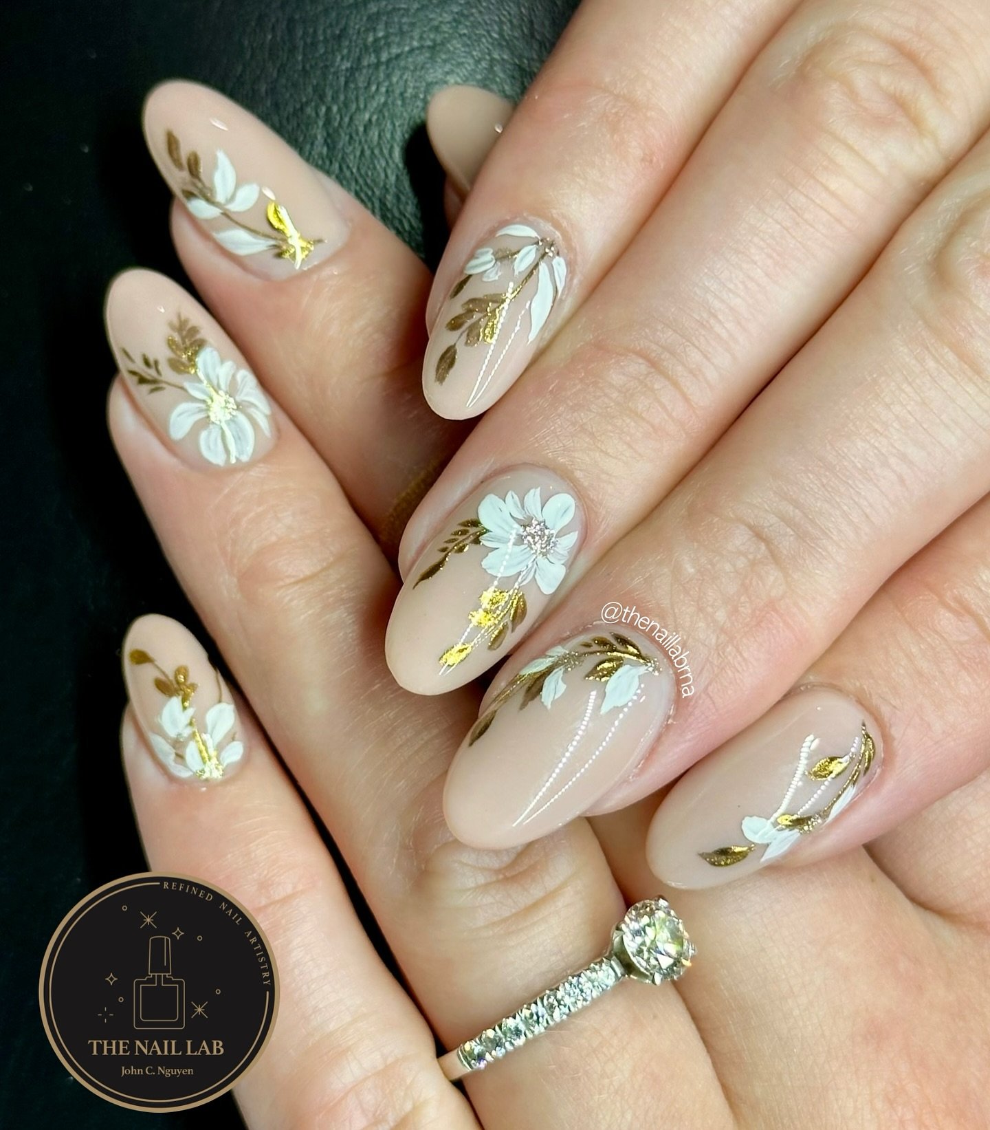 Milky Nude Almond Nails with White and Yellow Floral Accents