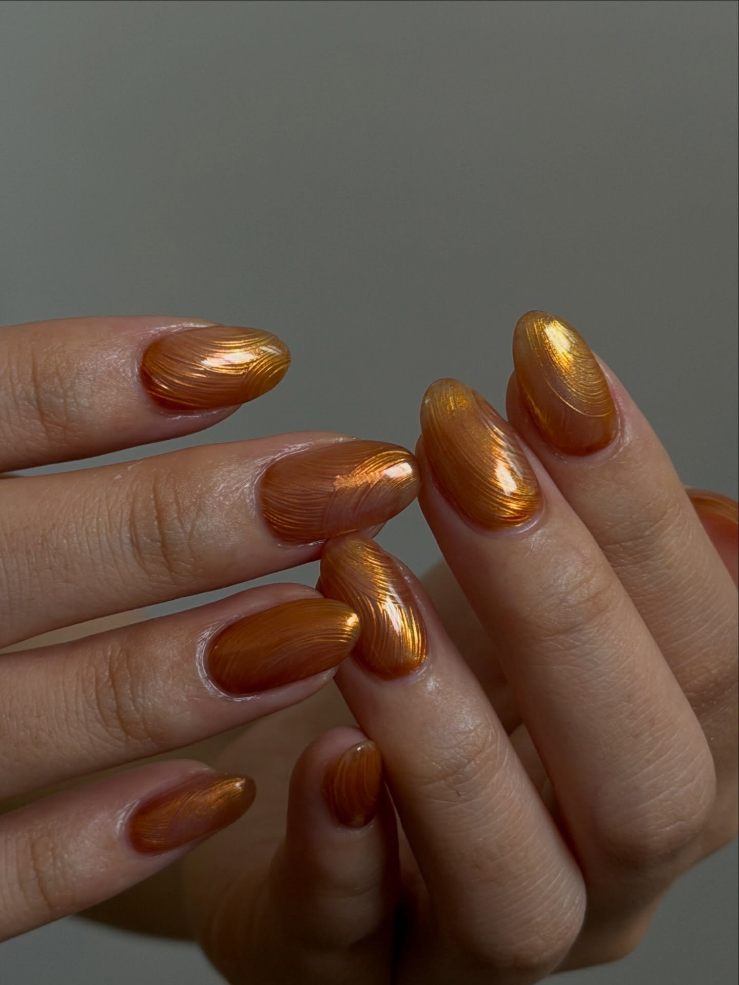 Short Amber Bronze Nails with a Metallic Glow