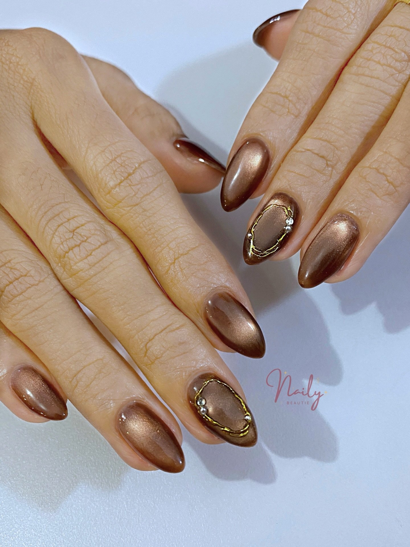 Bronze Almond Nails with Gold Oval Embellishments