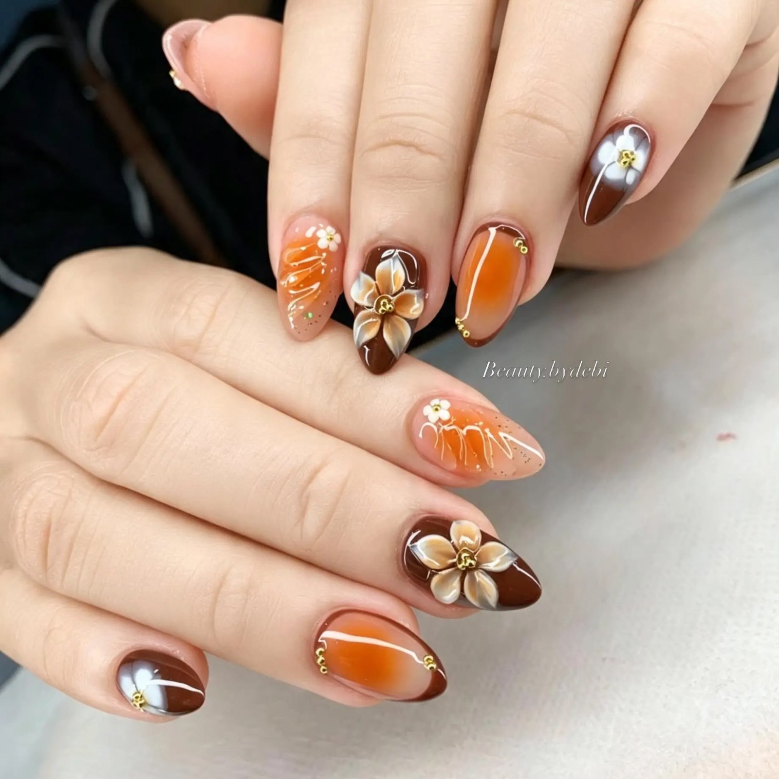 Warm Orange-Bronze Almond Nails with Floral Accents