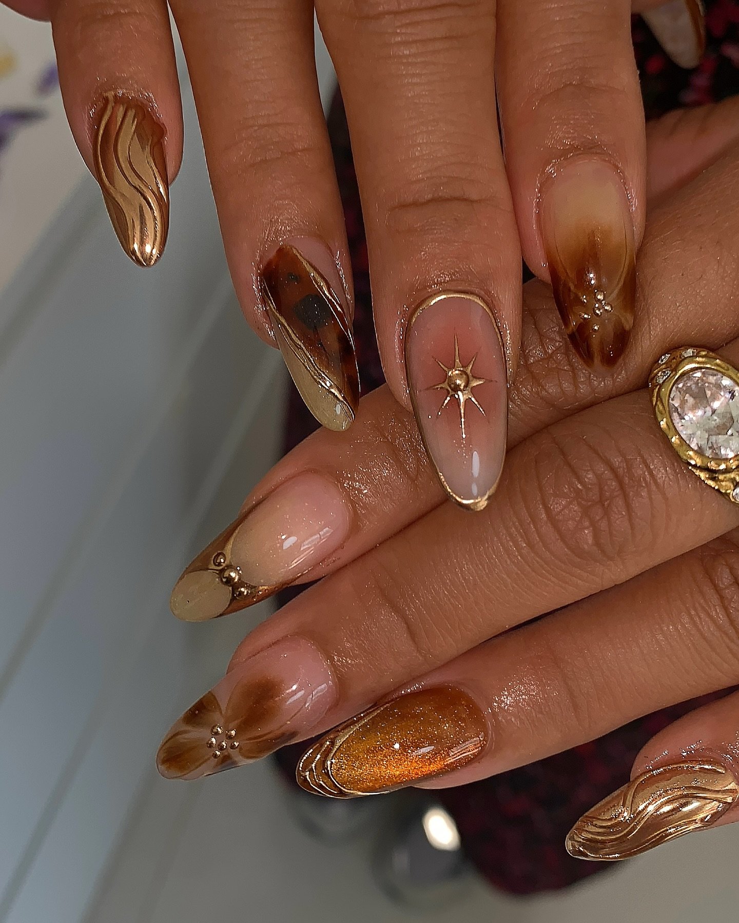 Nude Almond Nails with Bronze and Gold Accents