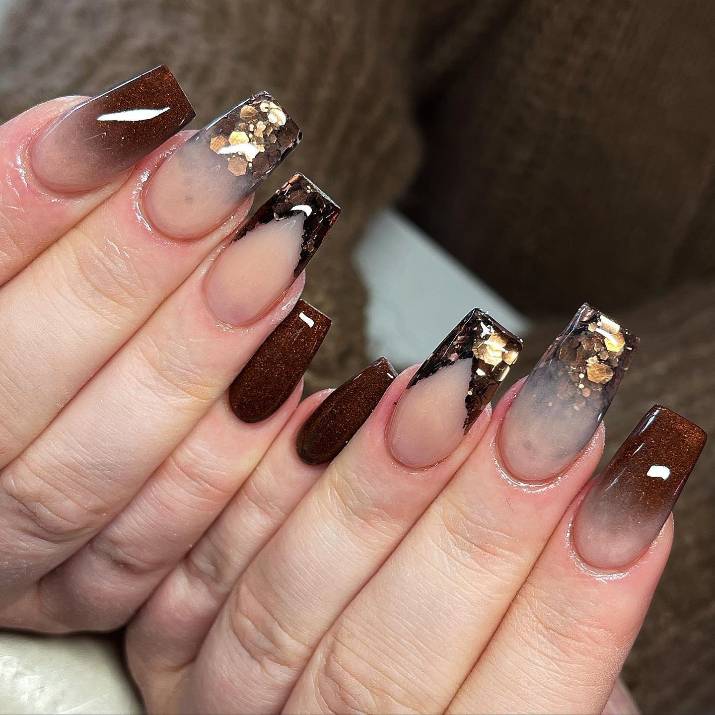 Clear Nude Nails with Bronze and Black Accents