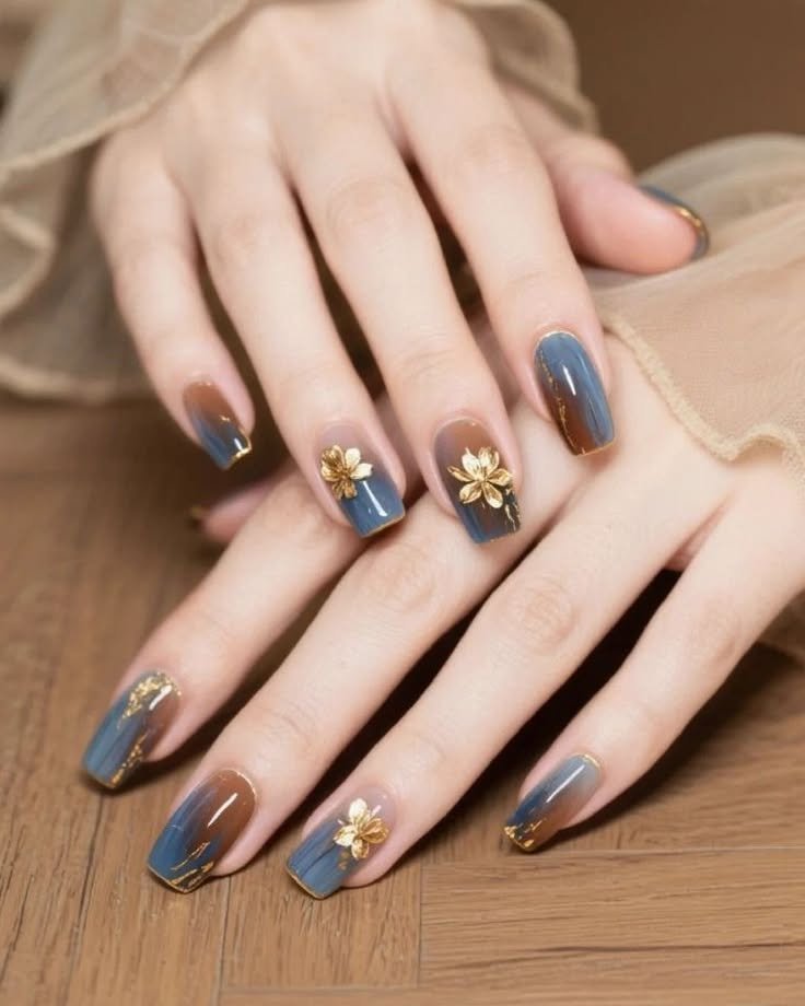 Blue-Tipped Nails with Bronze Floral Accents