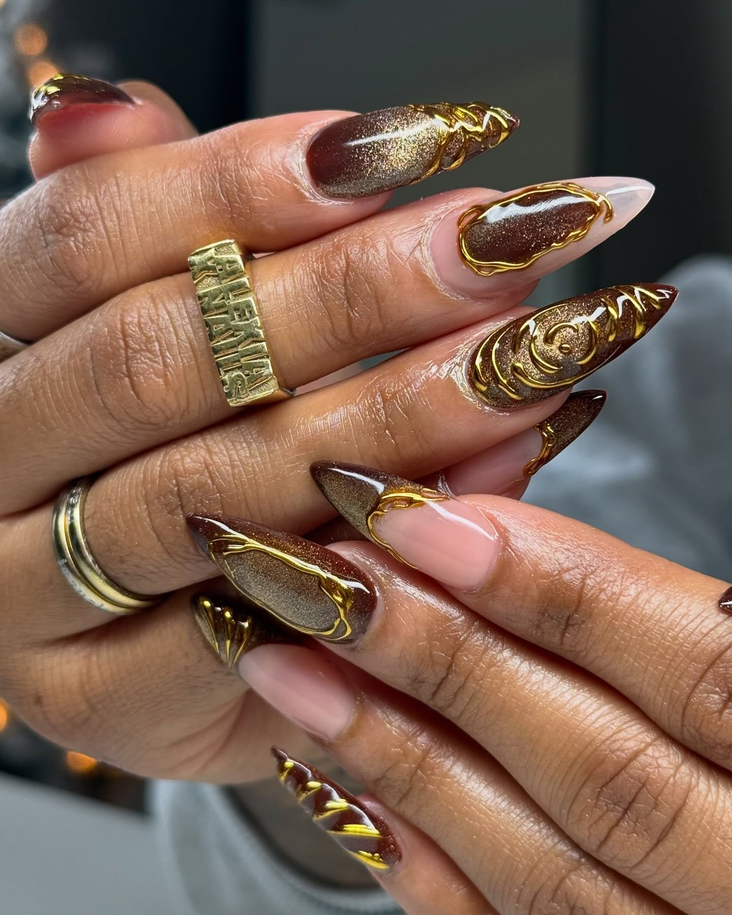Brown Chrome Nails with Gold Swirl Accents