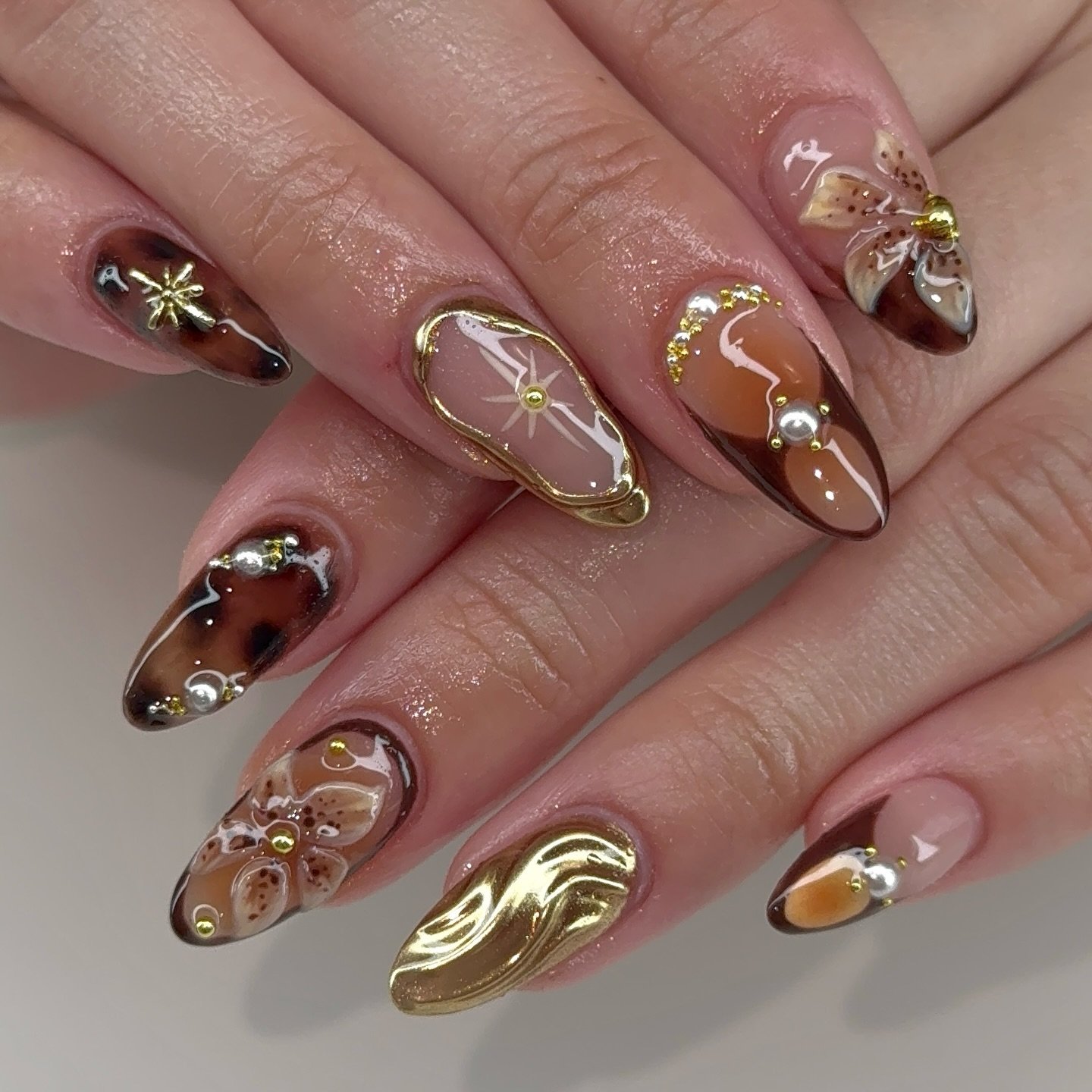 Brown Chrome Nails with Ornate Gold Details