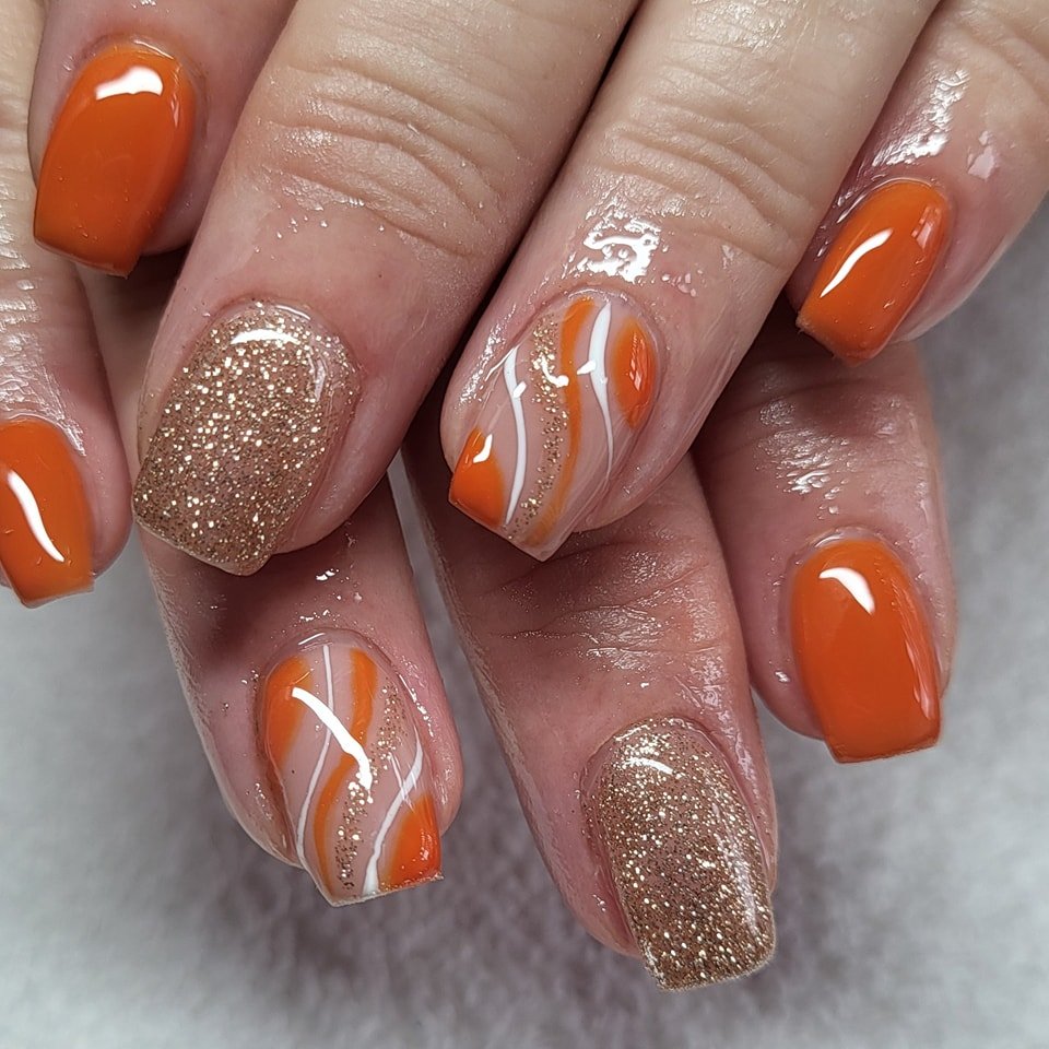 Glossy Orange and Glitter Nude Swirl Nails