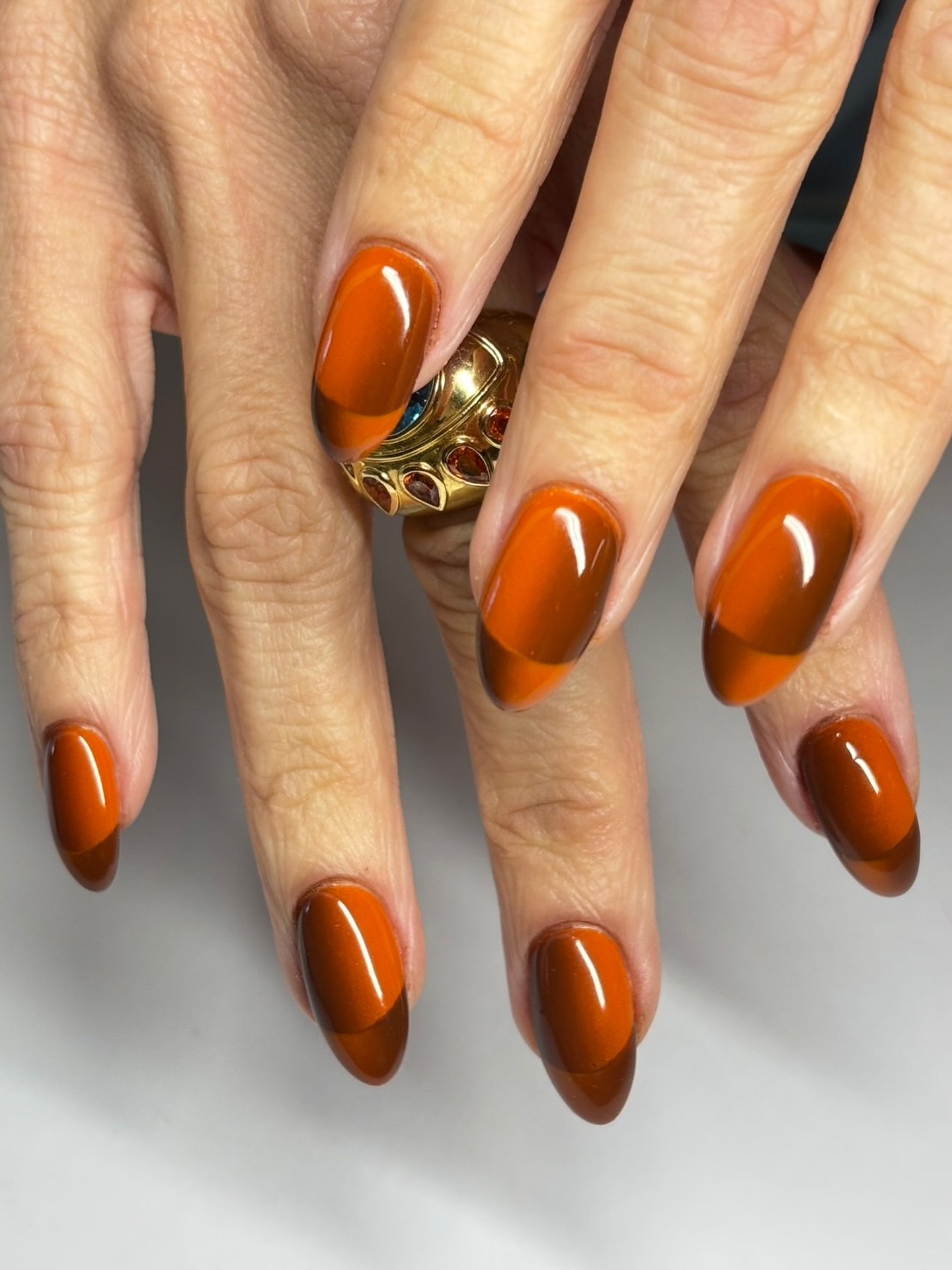 Long Orange Almond Nails with Brown Details