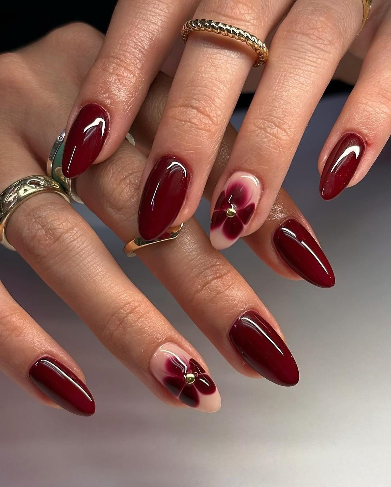 Long Burgundy Almond Nails with Floral Accents — DNgCVWqoGFZBeautyJayAesthetics Natural Nails Manicurist.jpg