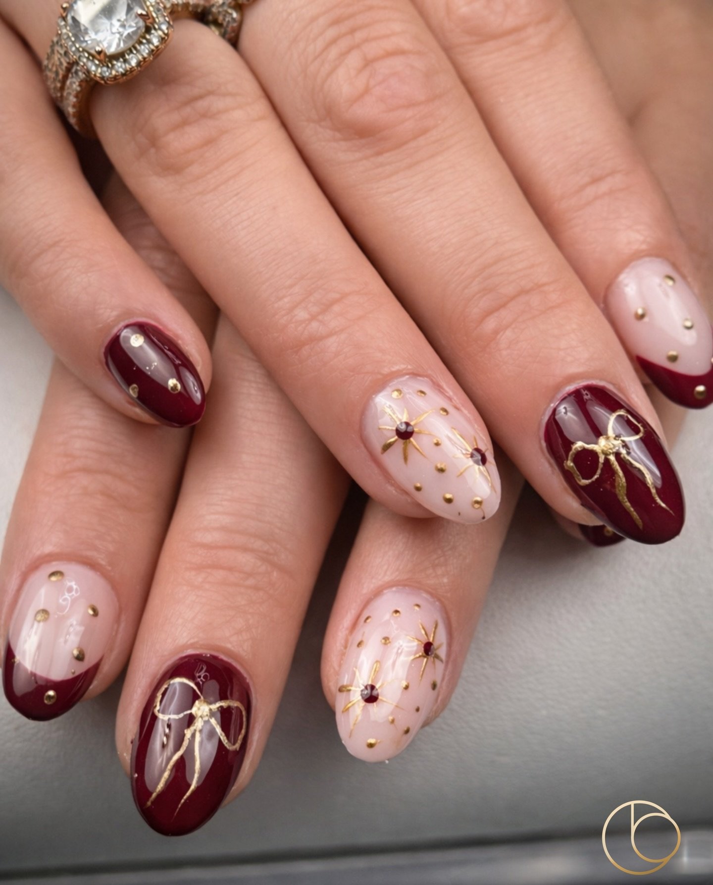 Burgundy and Nude Almond Nails with Gold Linework — DSxJRcBjc9ECode of Beauty Beauty Salon Cork.jpg