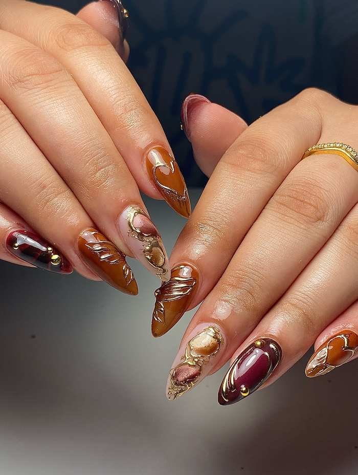 Long Almond Nails with Burnt Orange Marble and Gold Accents
