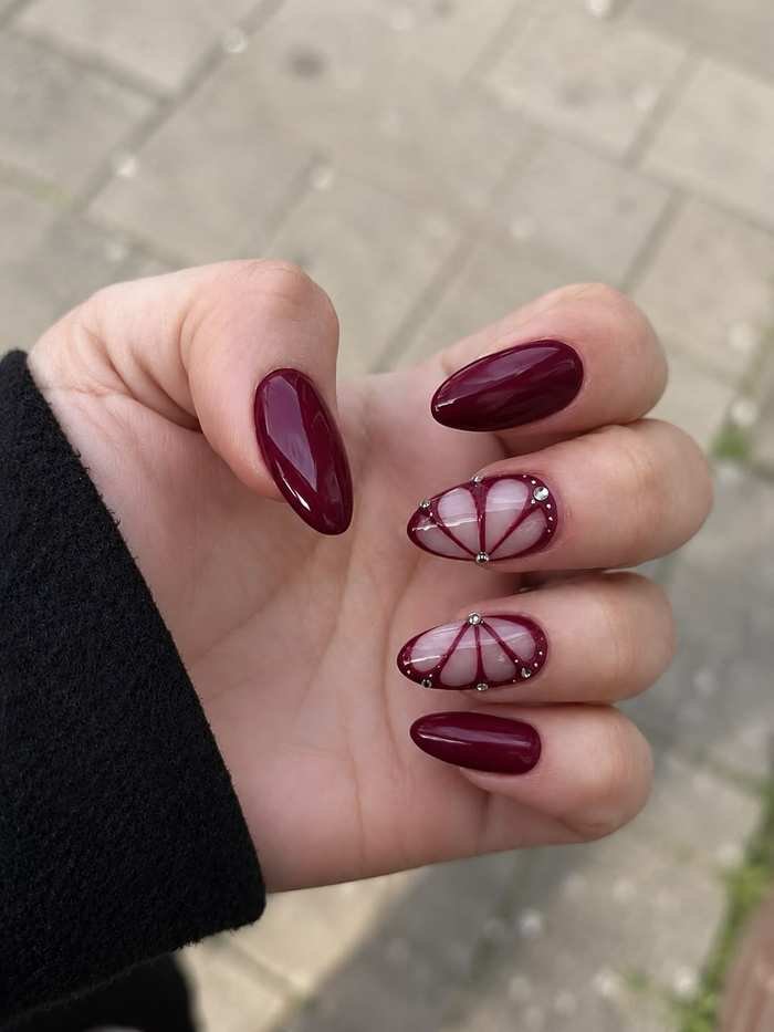 Short Burgundy Oval Nails with Fine Line Art