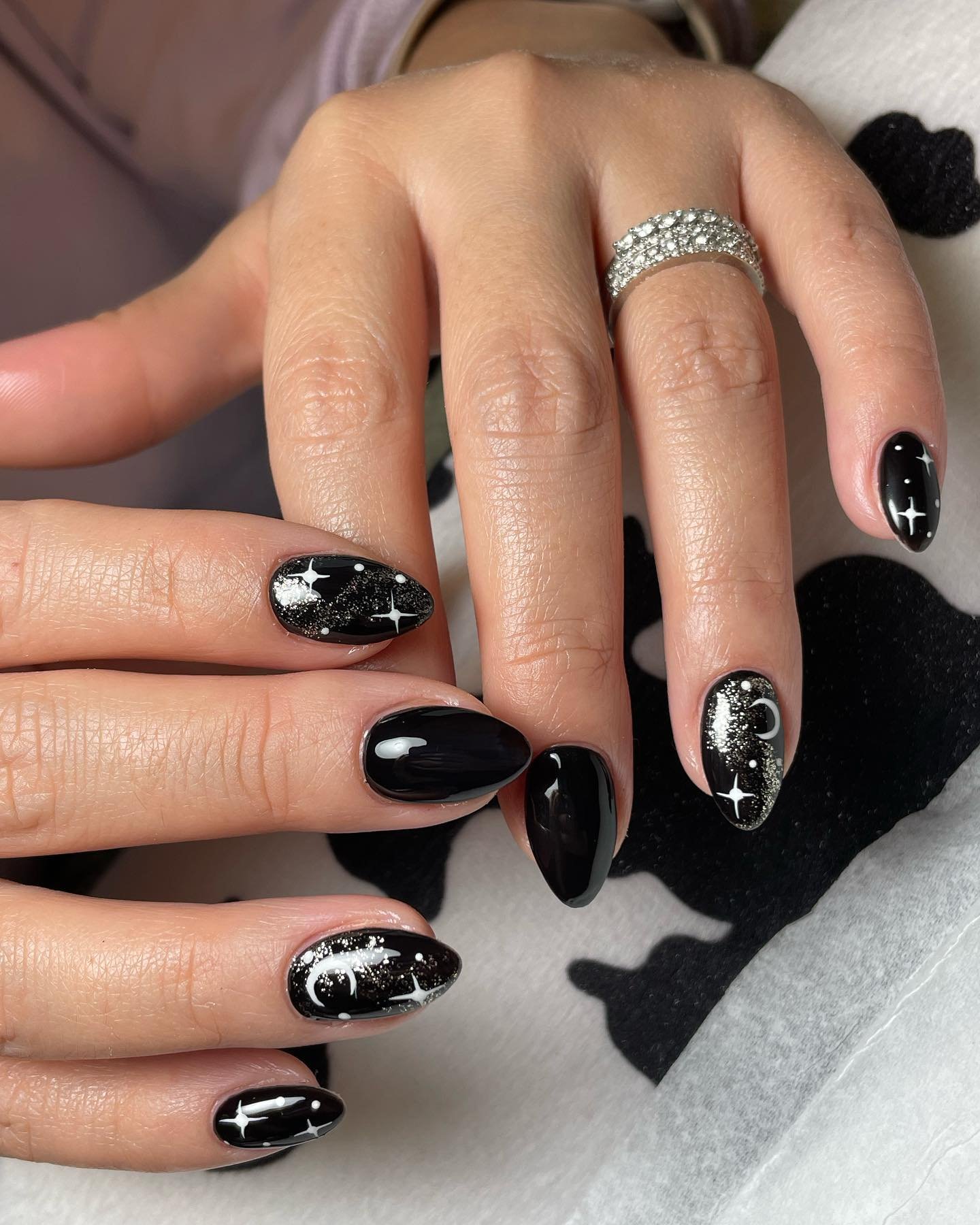 Glossy Black Almond Nails with White Celestial Line Art — CpvVlEZjZiP.jpg