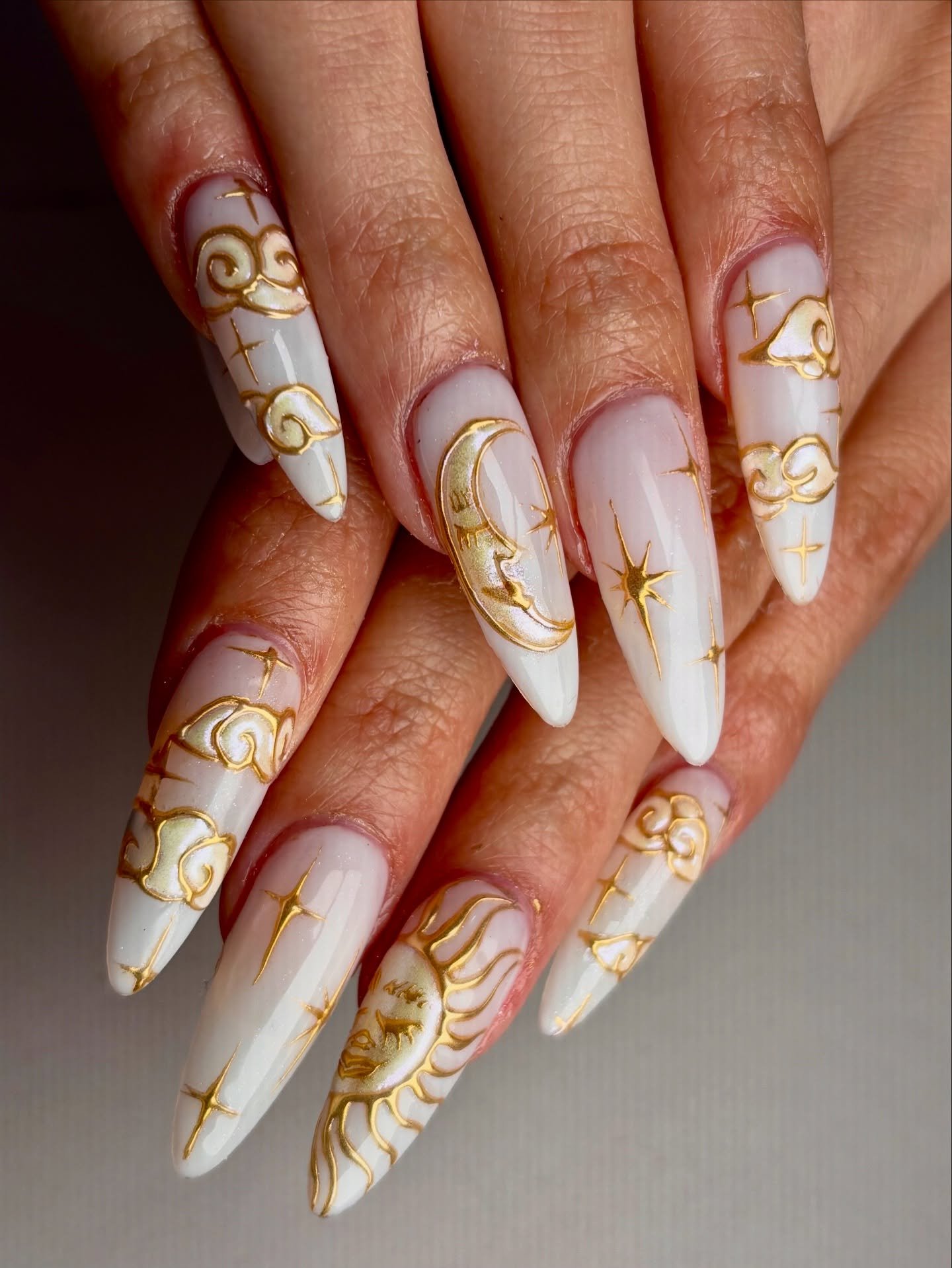 White Stiletto Nails with Ornate Gold Celestial Patterns — DI4LzgeTZTIJas.jpg