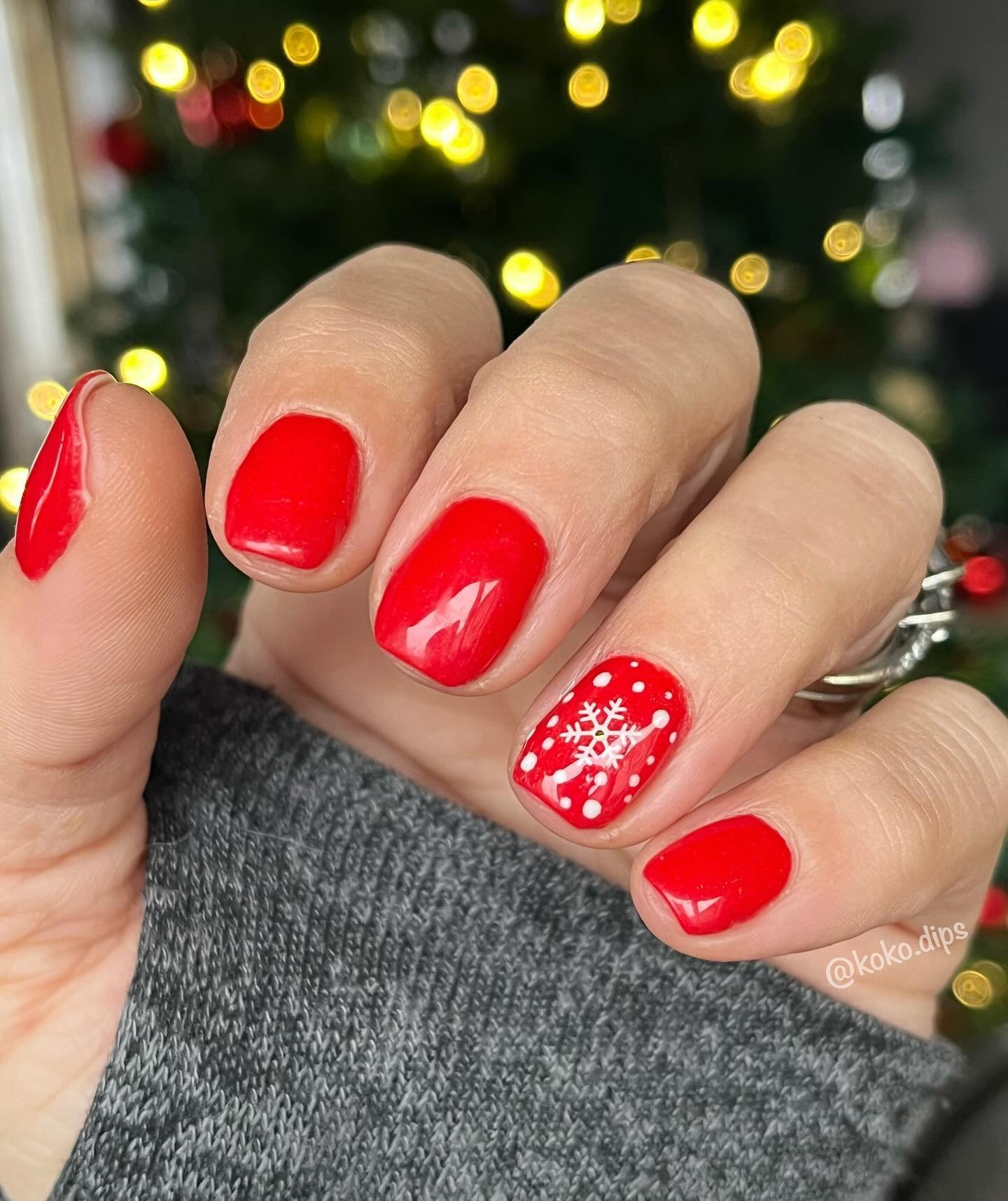 Short Red Glossy Nails with a White Dotted Christmas Accent