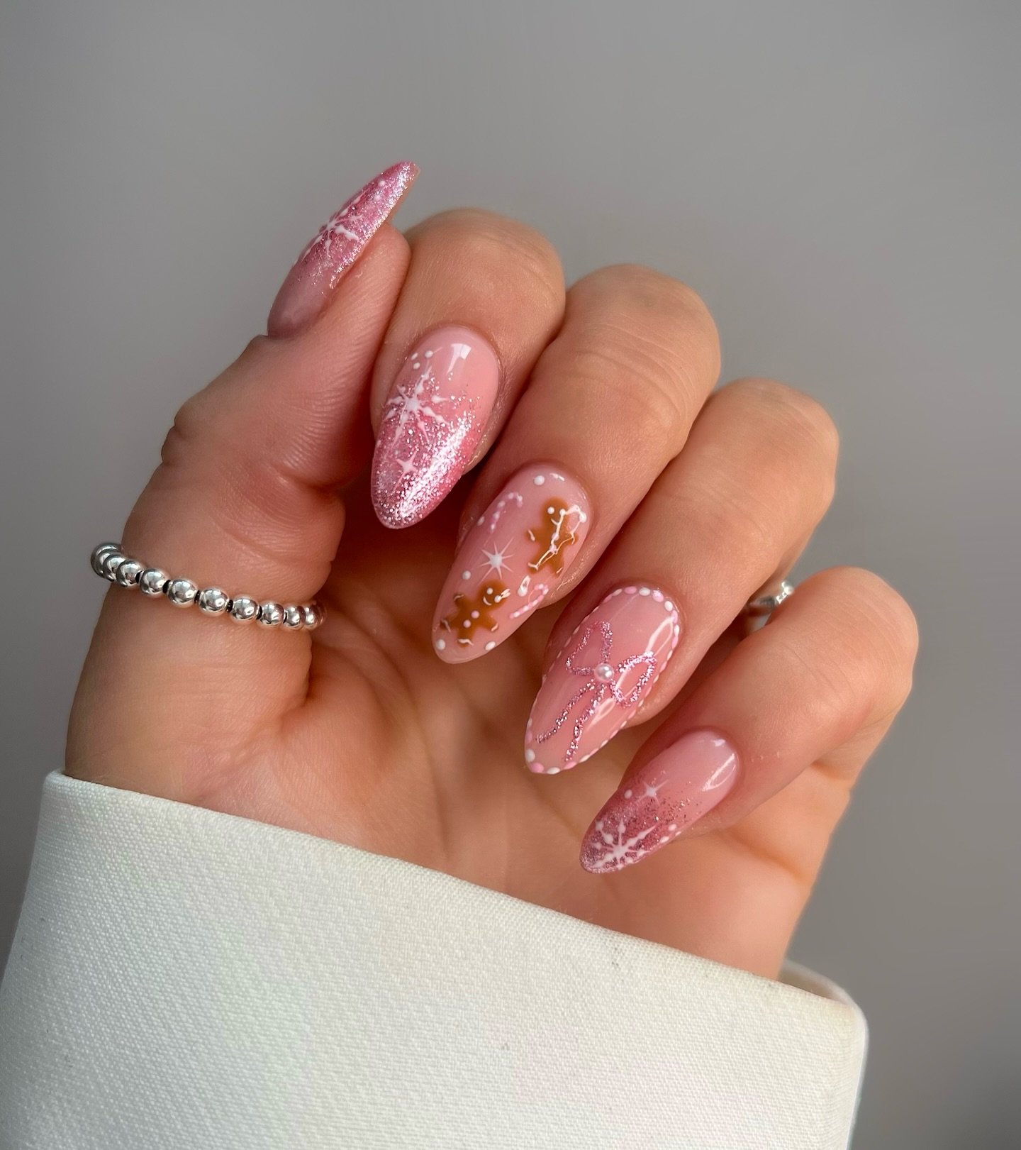 Soft Pink Glitter Almond Nails with Delicate White Details