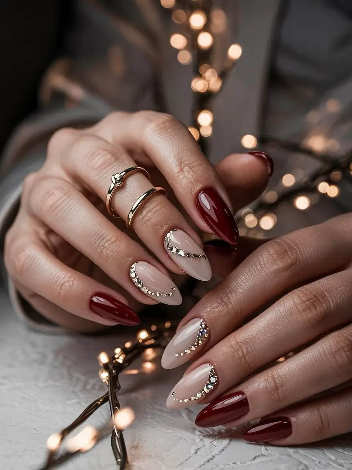 Burgundy and Nude Almond Nails with Fine Gold and Glitter Details