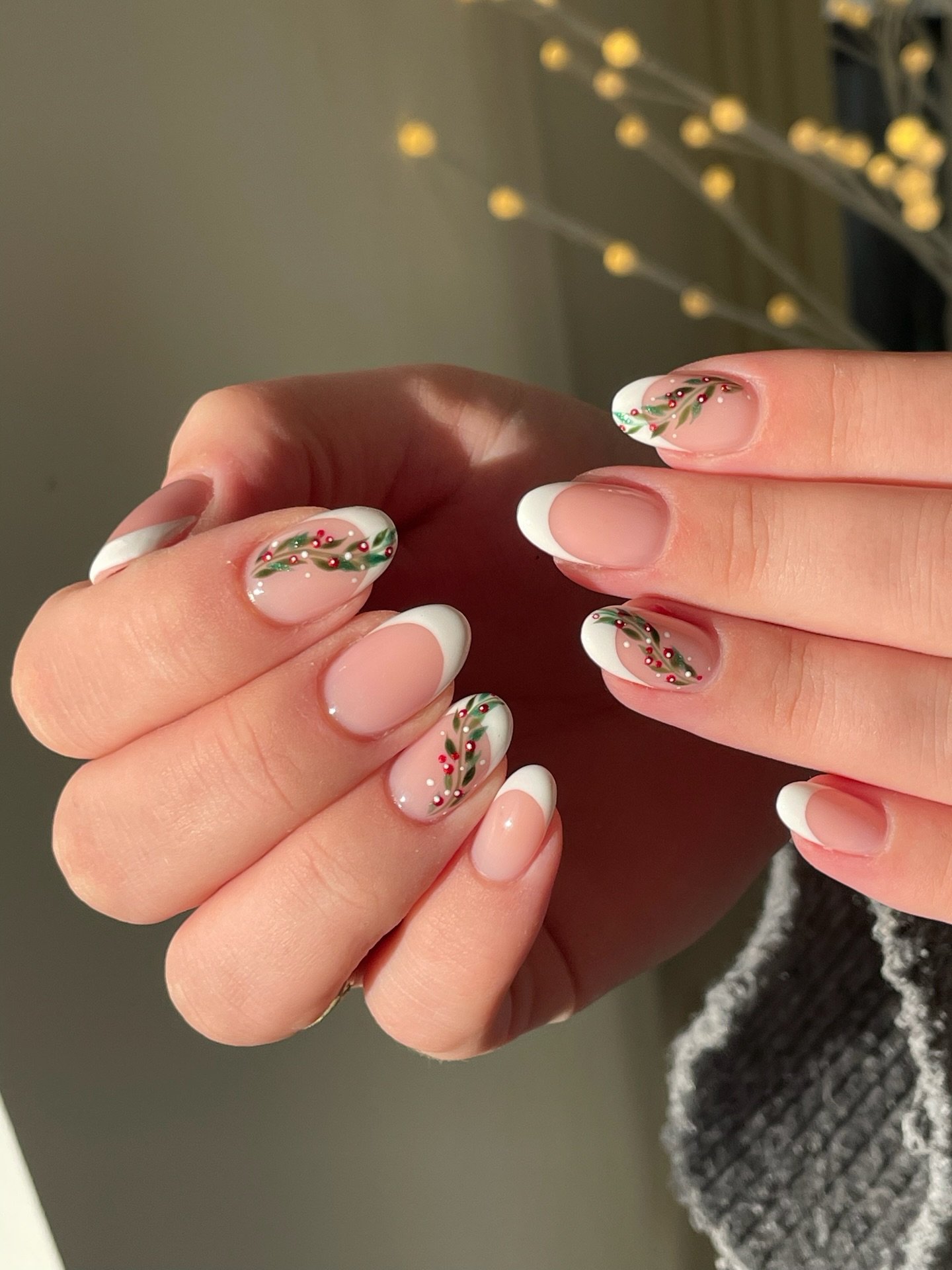 Sheer Pink Almond Nails with White Tips and Green Holiday Swirls