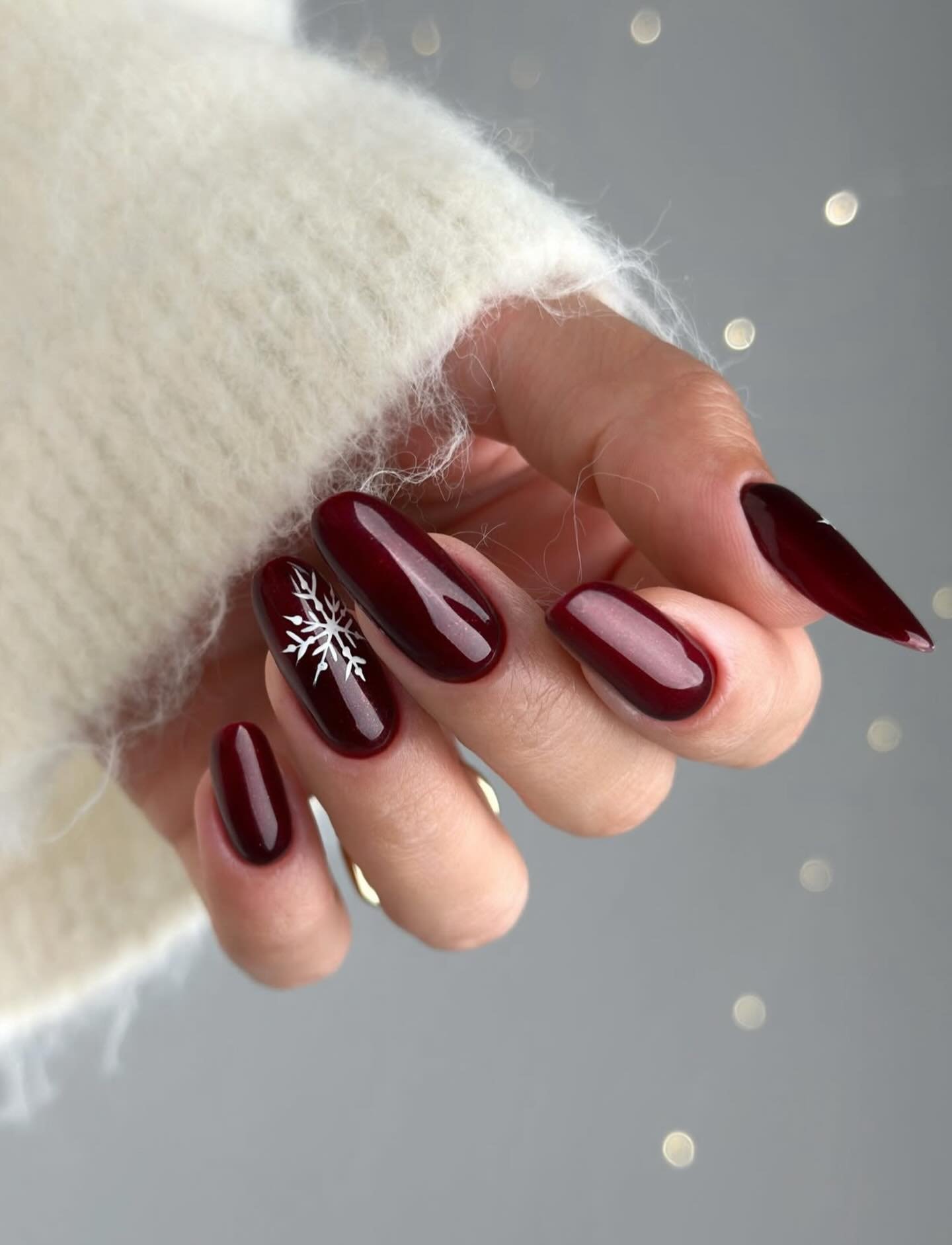 Deep Red Almond Nails with White Snowflake and French-Line Details