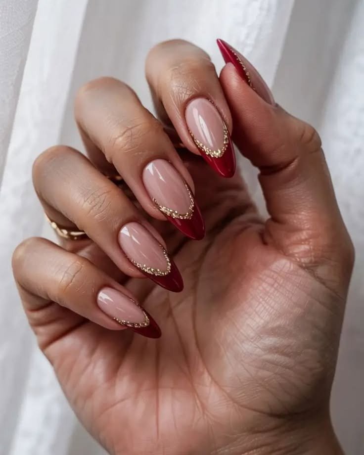 Blush Almond Nails with Deep Red French Tips and Gold Edges