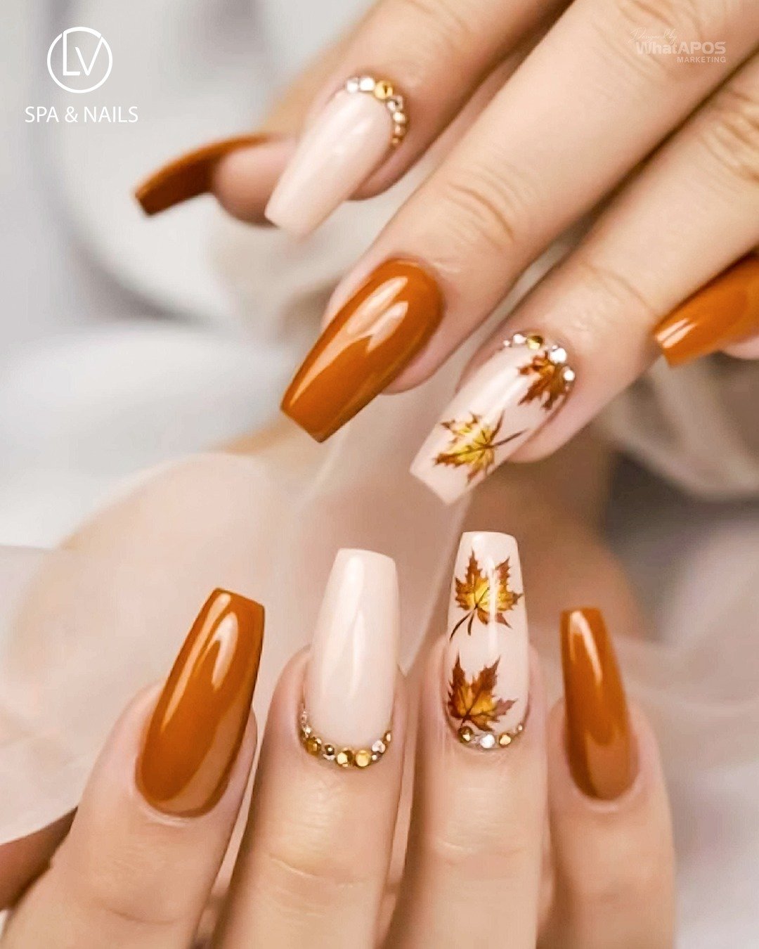 Orange and White Almond Nails with Delicate Leaf Motifs
