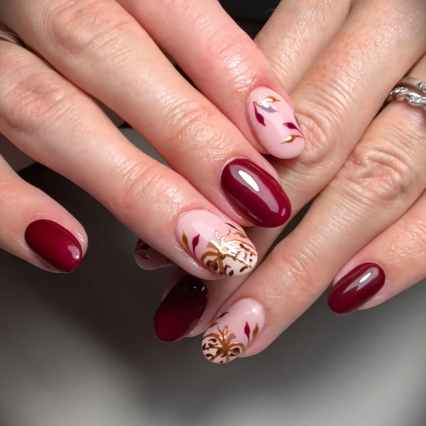 Pink and Burgundy Oval Nails with Copper Leaf Accents