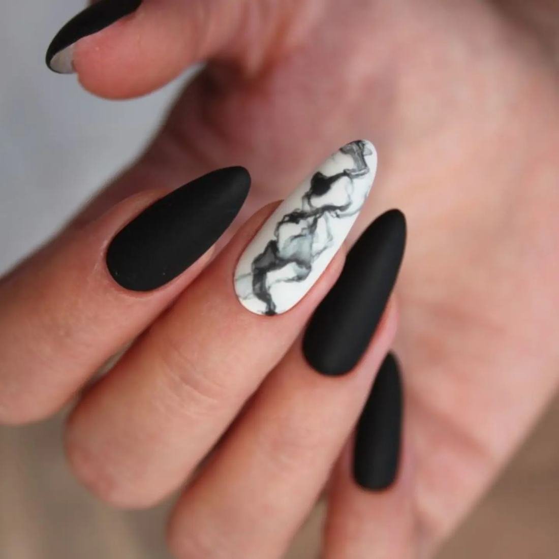 Matte Black Almond Nails with a Marble Accent