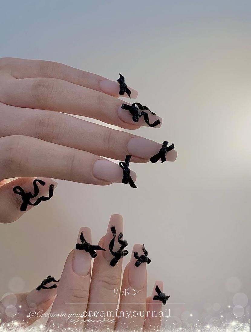 Pale Pink Almond Nails with Black Bow Details