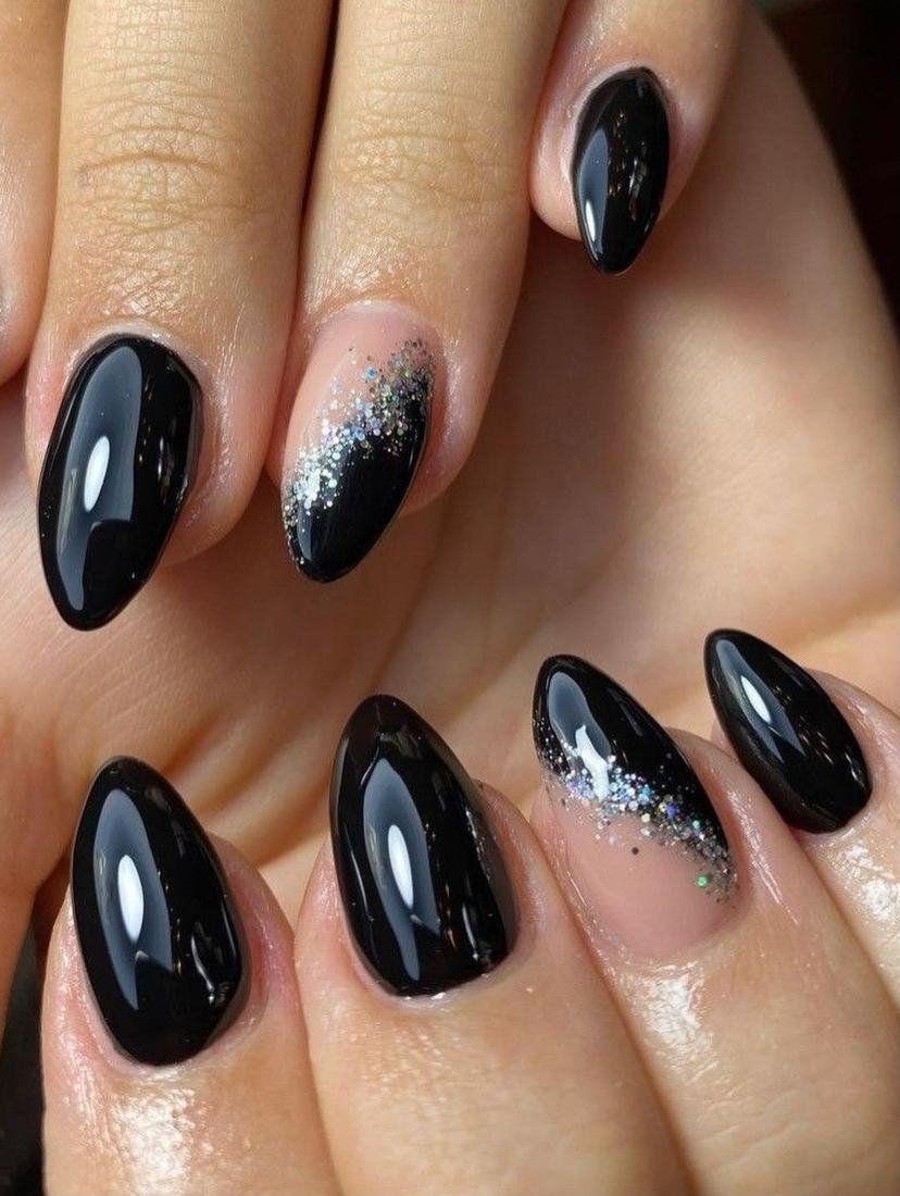 Glossy Black Almond Nails with a Glitter Accent