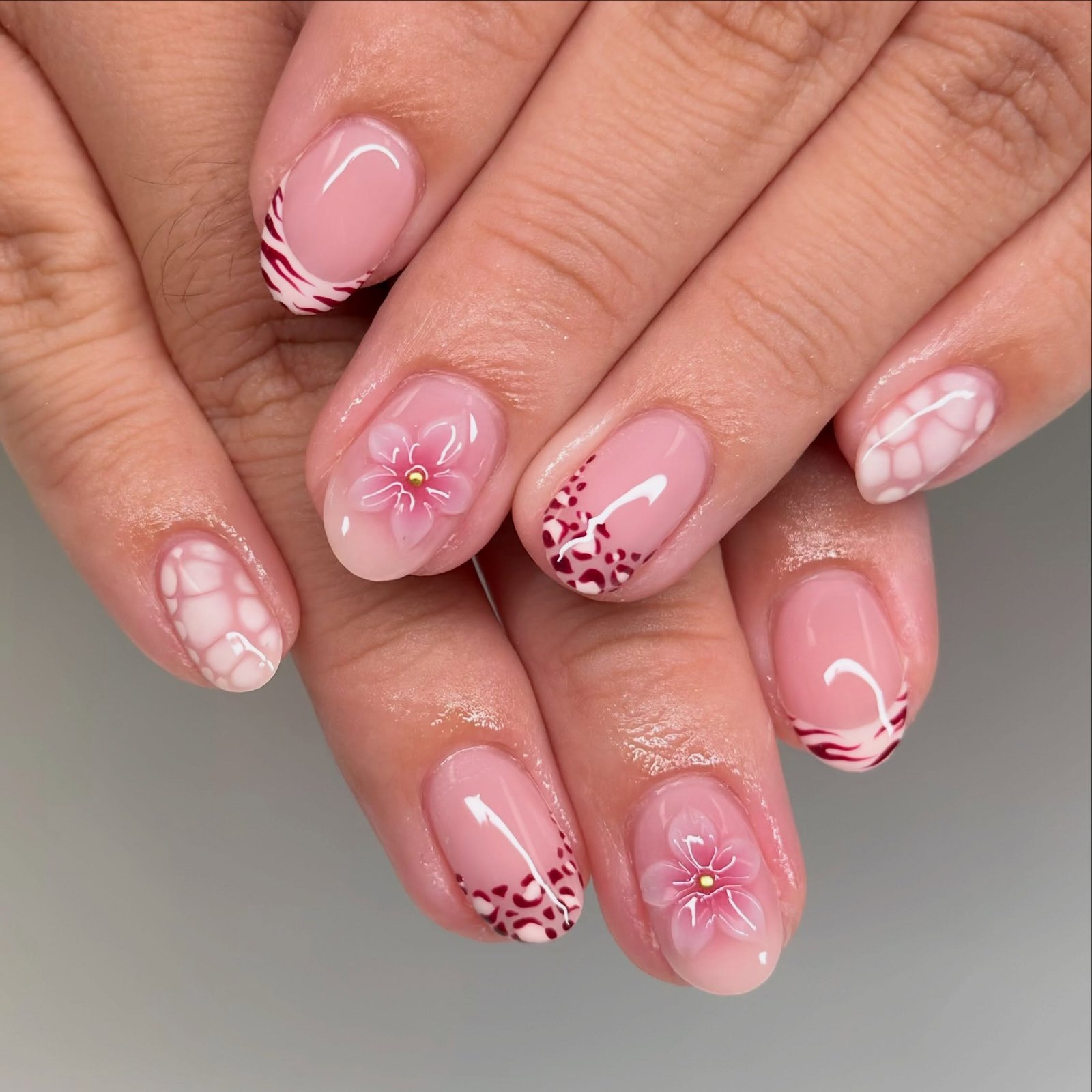Short Pink Nails with Florals, Swirls, and Burgundy Details