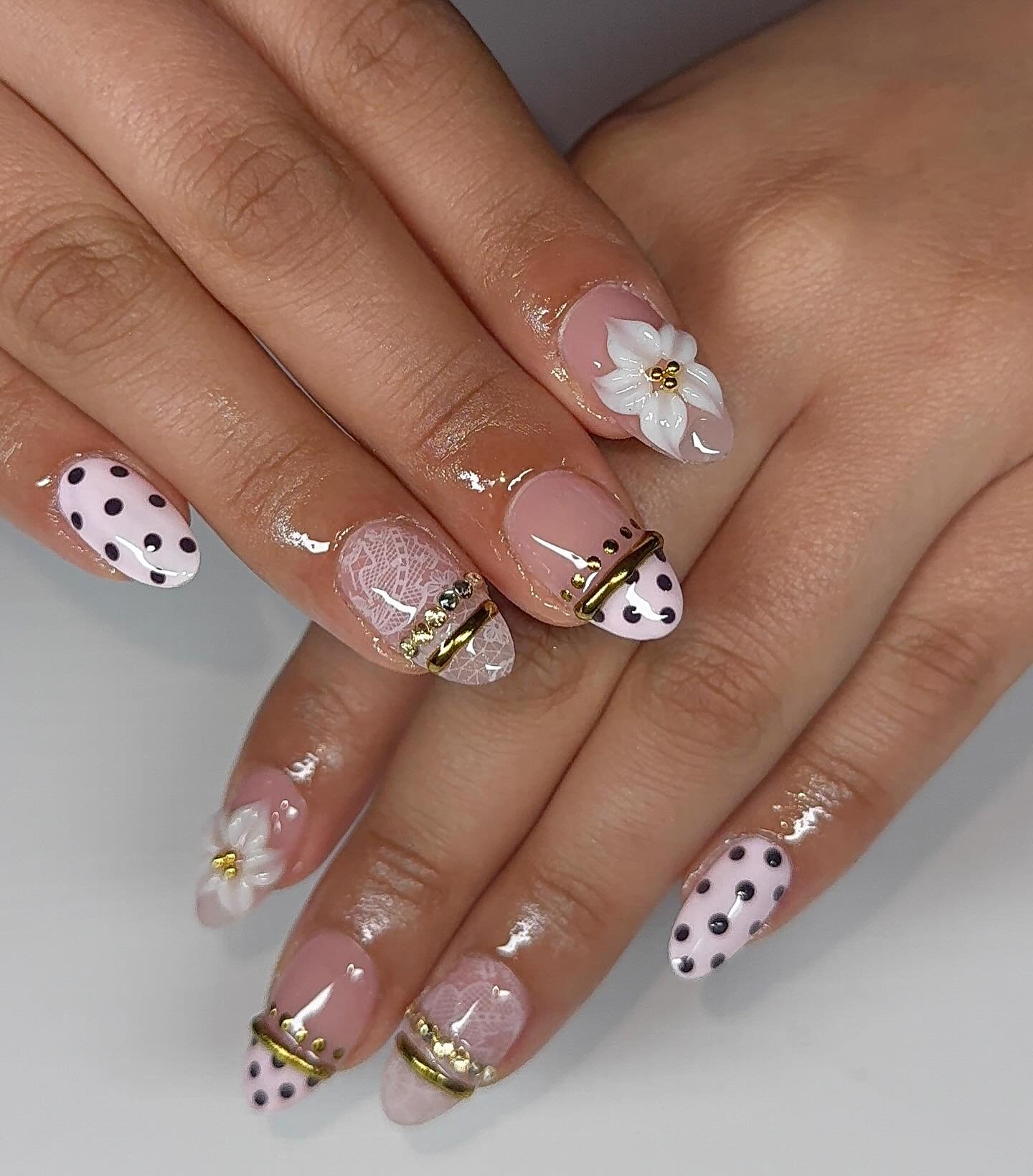 Short Nude Nails with Polka Dots, Gold Lines, and a White Flower