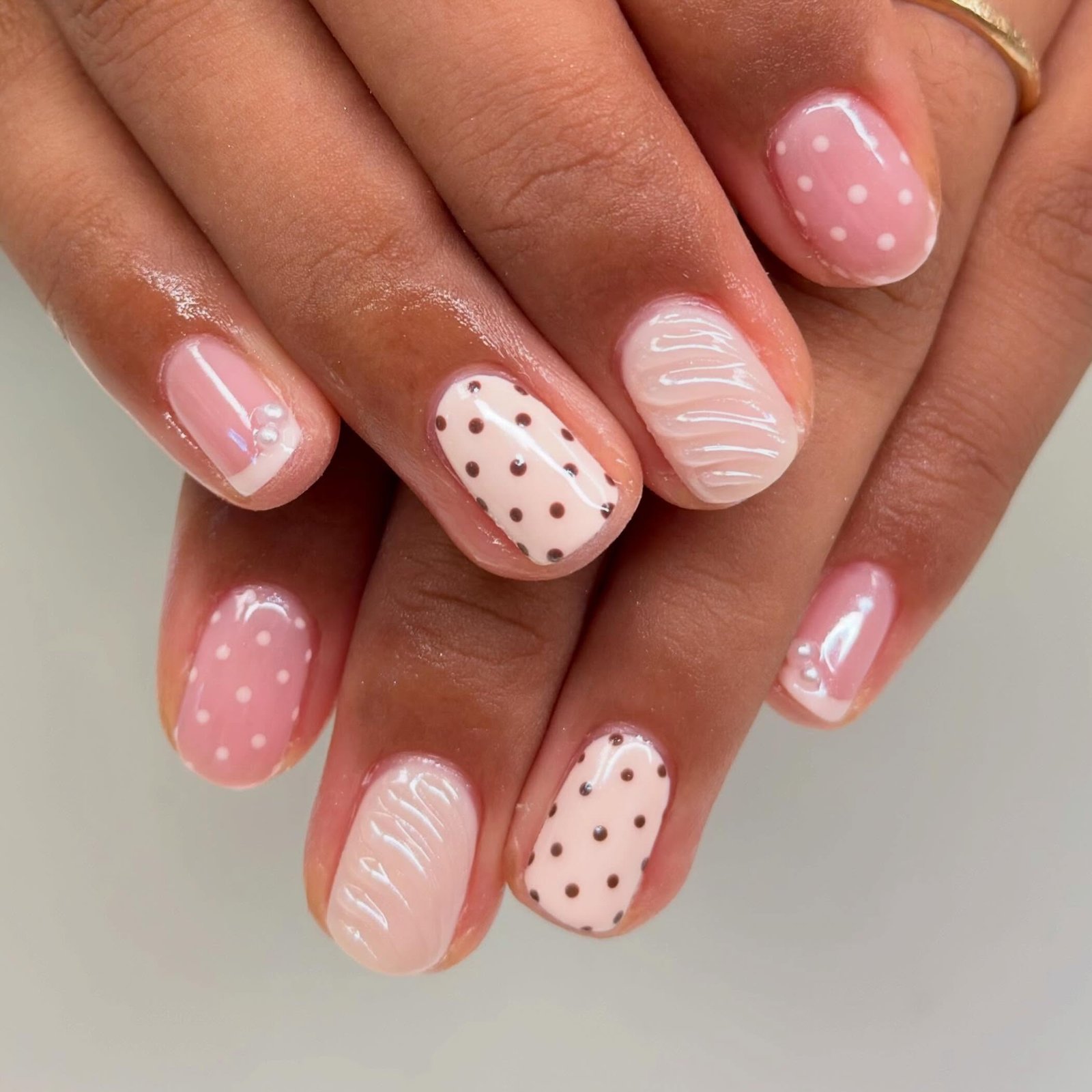 Short Pink Nails with White Polka Dots and Textured Lines