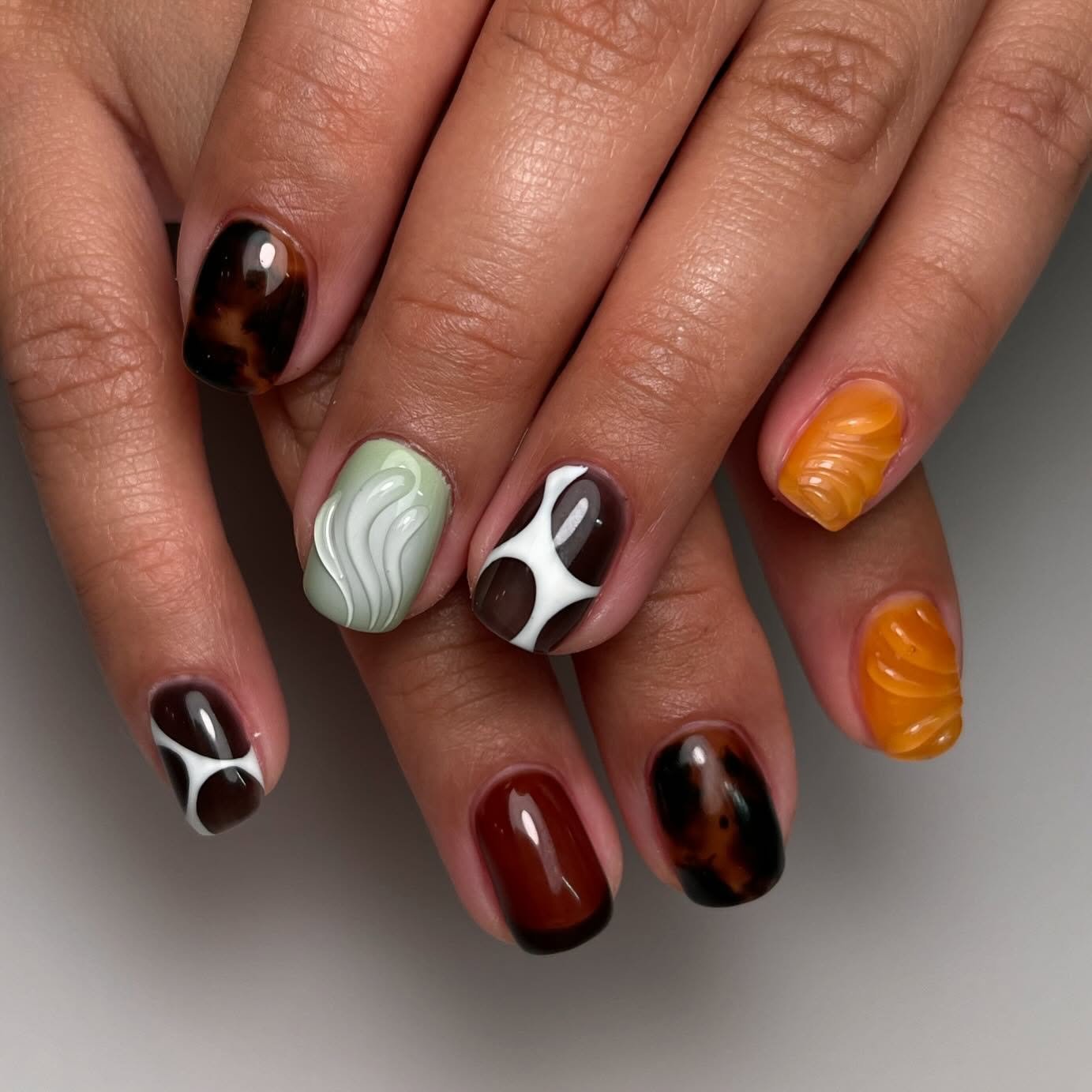Short Brown, Black, White, and Orange Mixed Nail Art