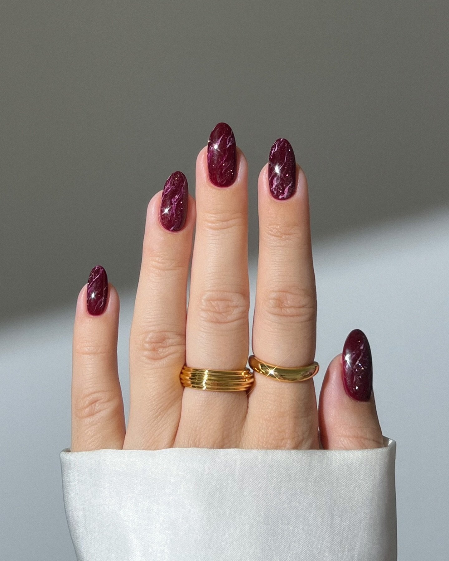 Deep Burgundy Almond Nails with Subtle Shimmer