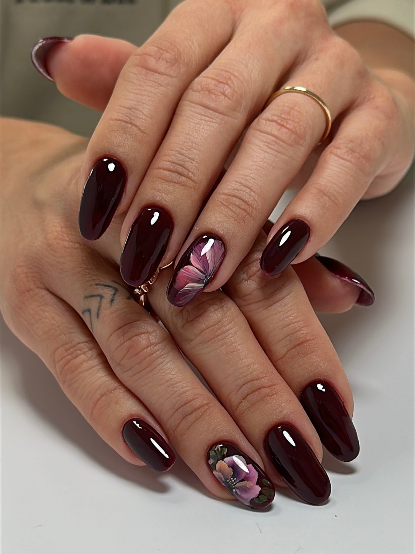 Glossy Burgundy Nails with Floral and Abstract Accents