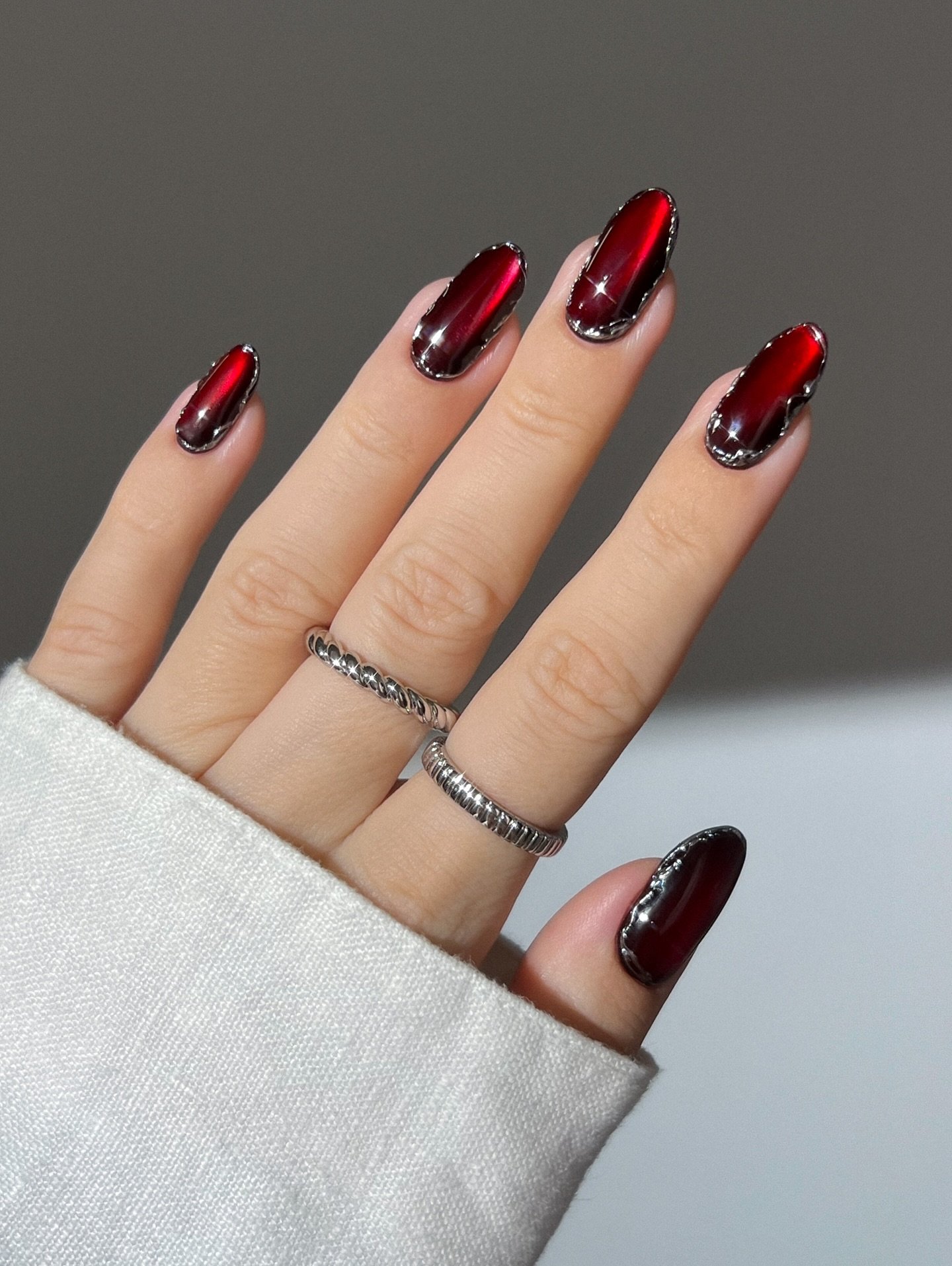 Black and Red Almond Nails with Glitter Accents